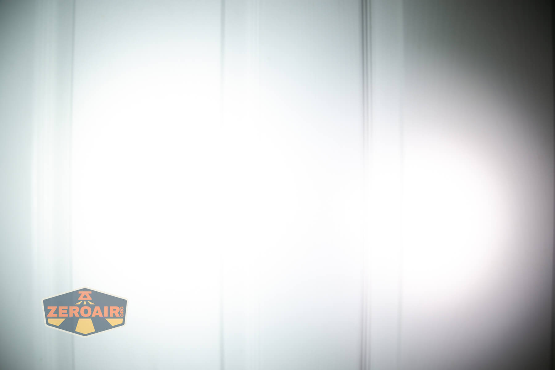 Wuben X1Pro Flashlight beamshots on door compared to Nichia 219b