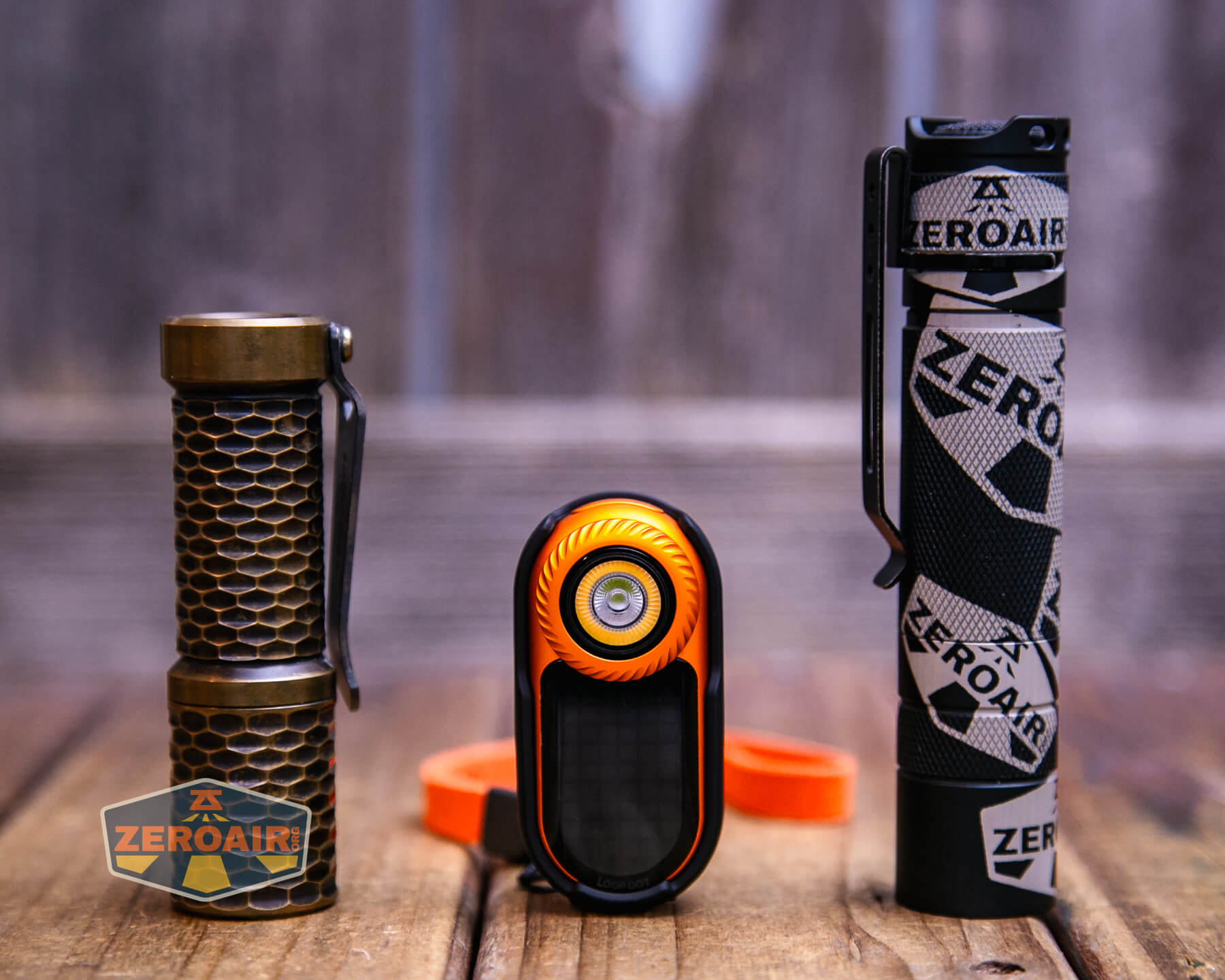 LoopGear LoopDot Orange Pixel Display EDC flashlight with two standard sized flashlights
