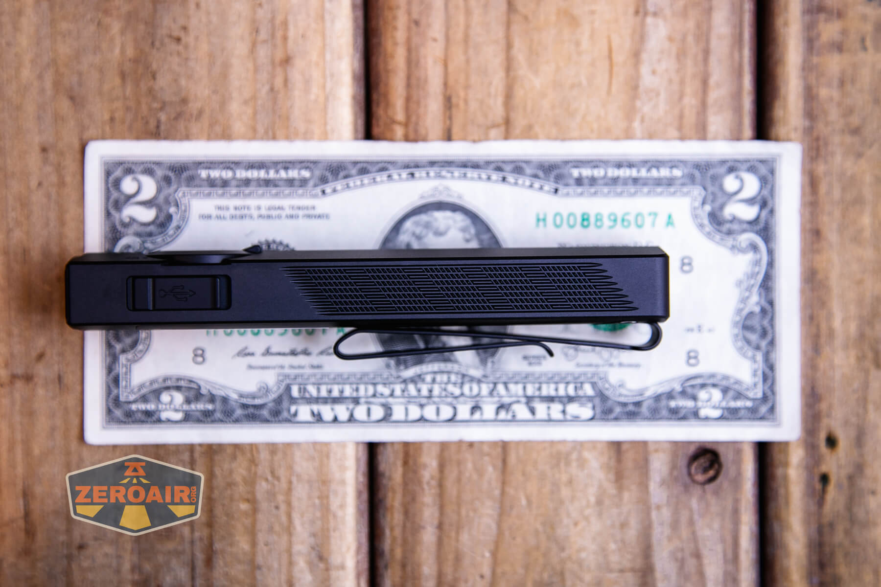 Olight ArkPro Matte Black cool white on two dollar bill