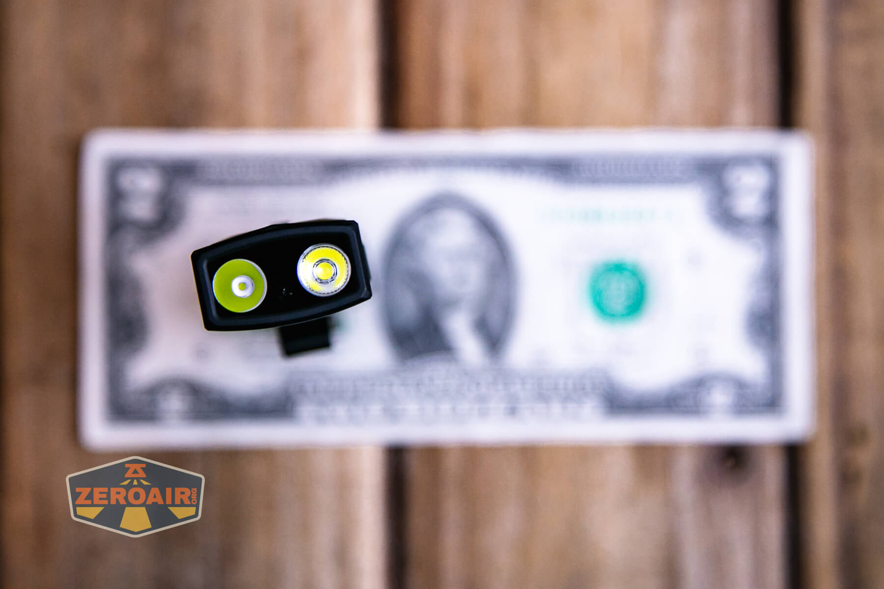 Olight ArkPro Matte Black cool white on two dollar bill