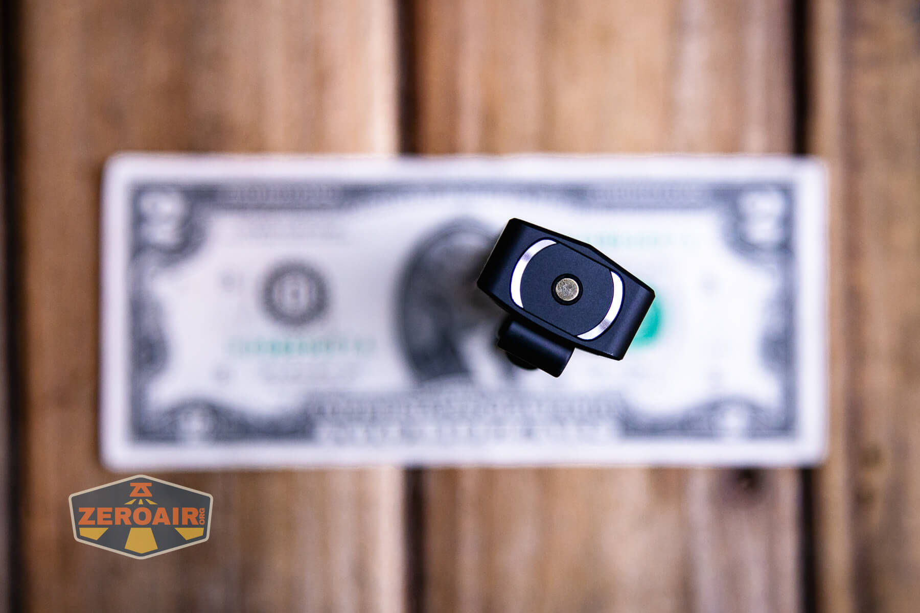 Olight ArkPro Matte Black cool white on two dollar bill