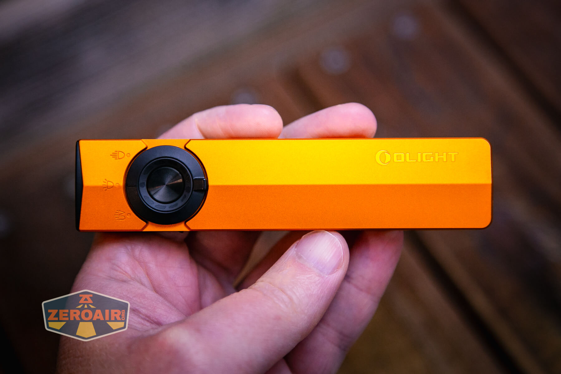 Olight ArkPro Orange flashlight in hand