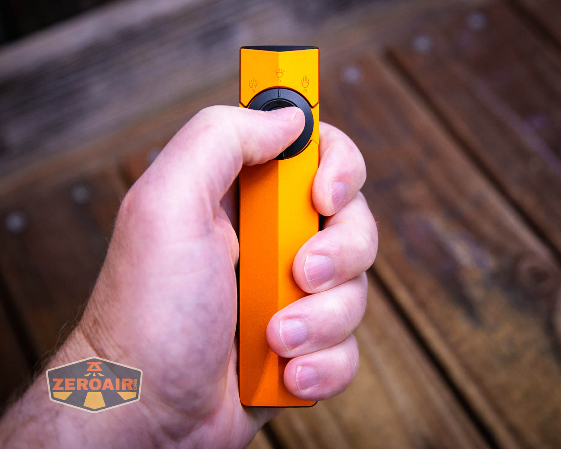 Olight ArkPro Orange flashlight in hand