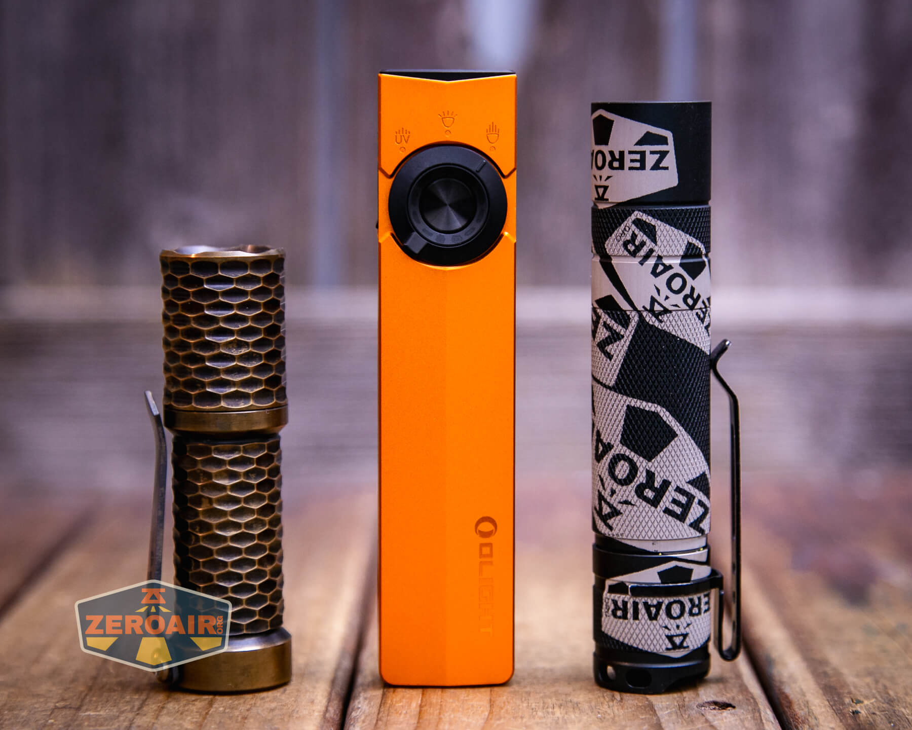 Olight ArkPro Orange flashlight with standard-sized flashlights
