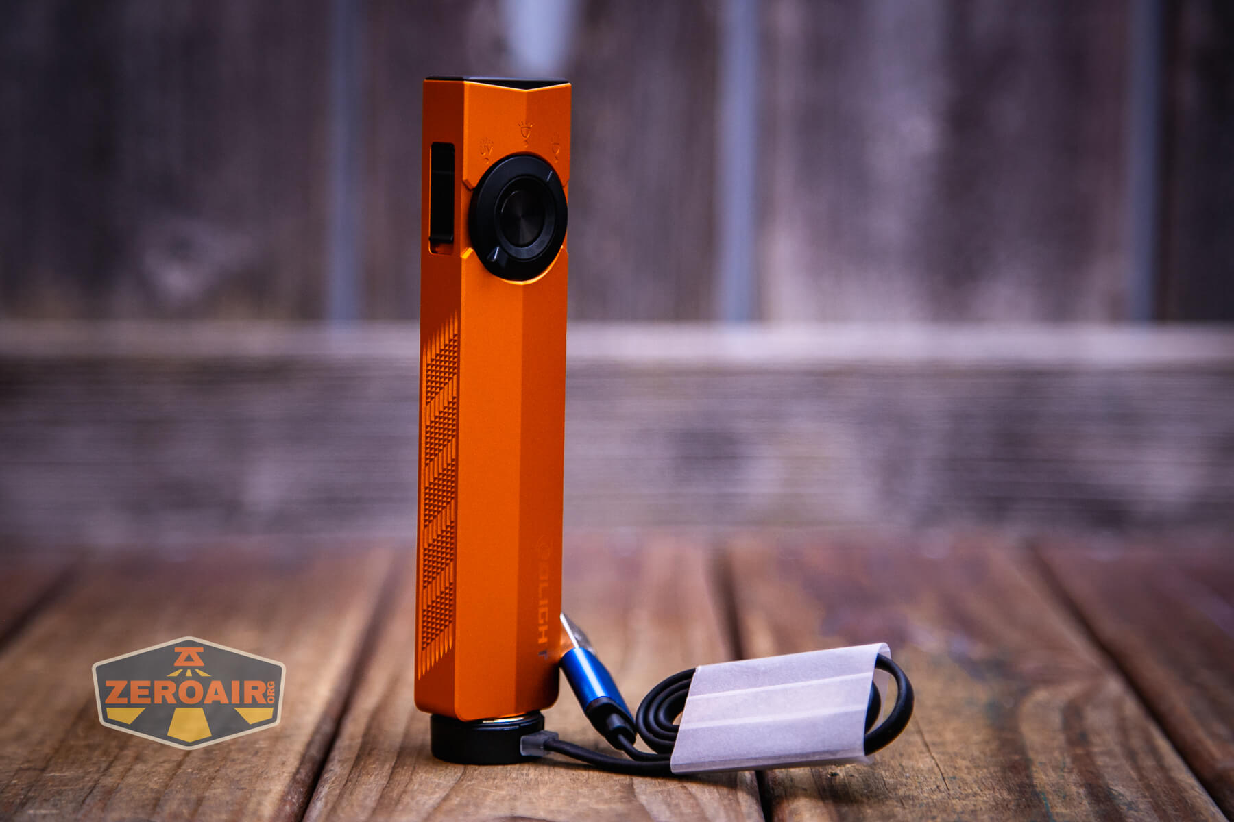 Olight ArkPro Orange flashlight charging base connected