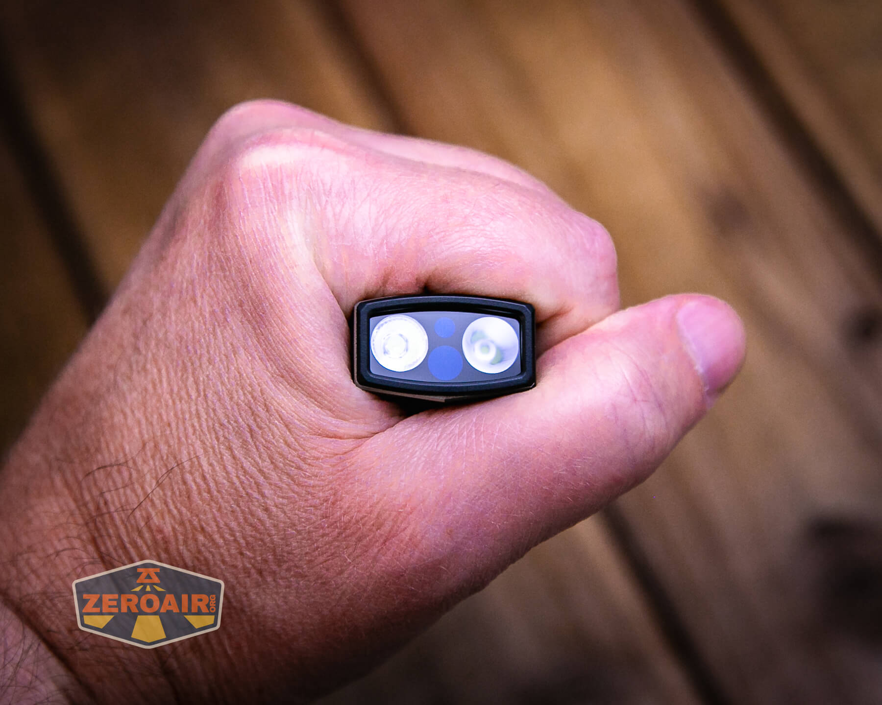 Olight ArkPro Silver flashlight in hand