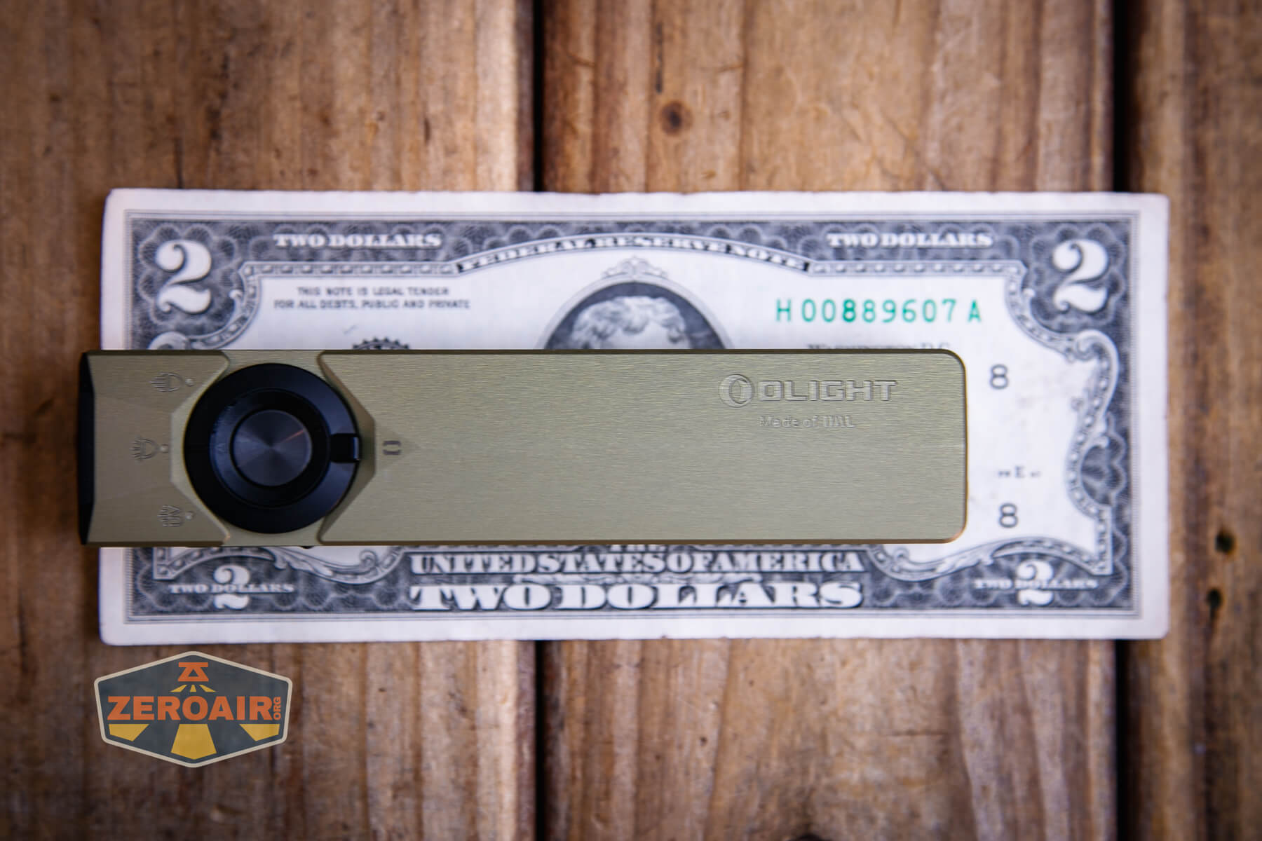 Olight ArkPro Ultra flat edc flashlight on two dollar bill