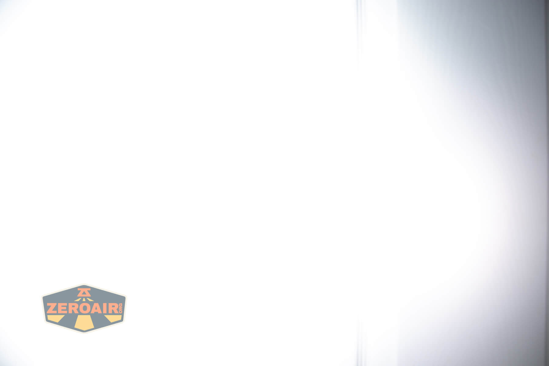 Olight ArkPro Ultra flat EDC flashlight beamshots on door compared to Nichia 219b