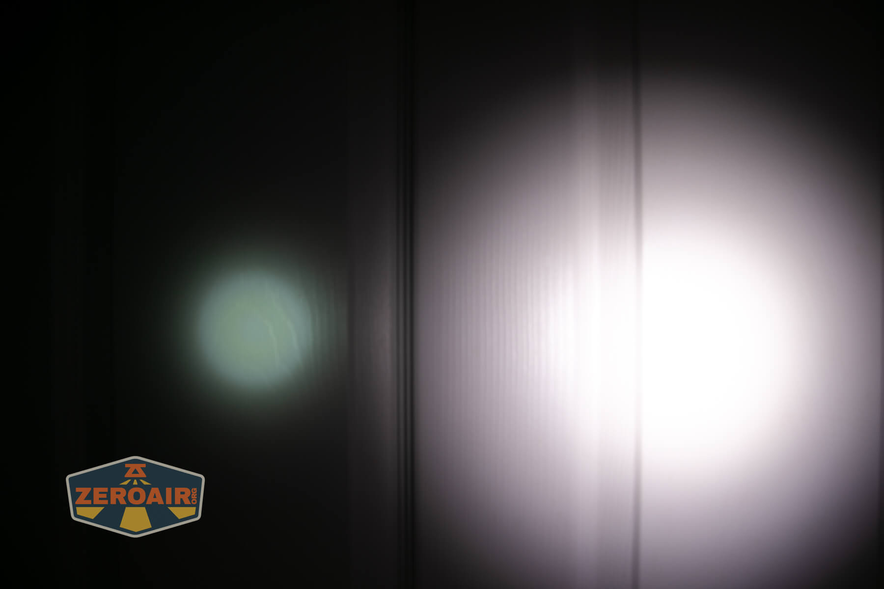 Olight ArkPro Ultra flat EDC flashlight beamshots on door compared to Nichia 219b