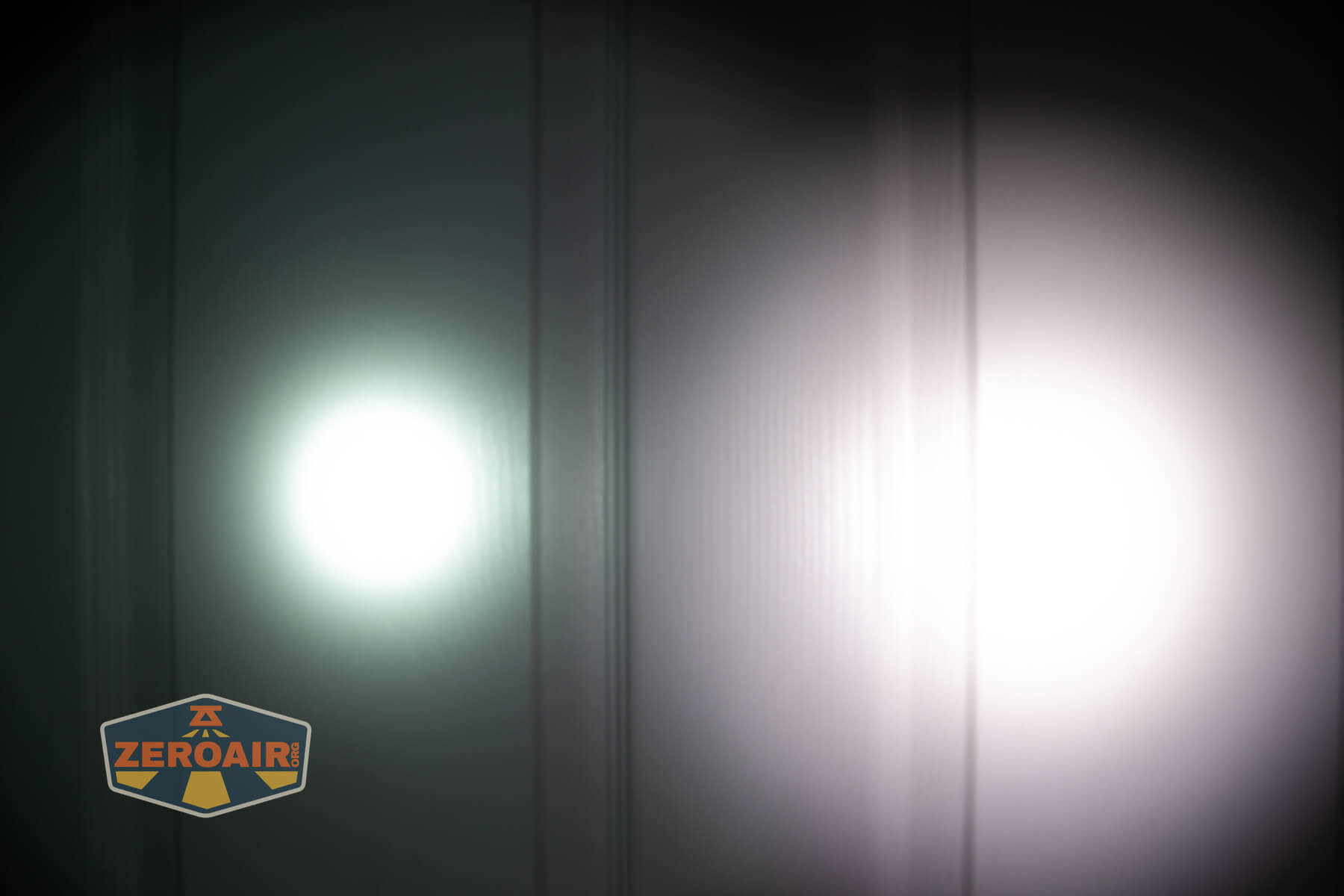 Olight ArkPro Ultra flat EDC flashlight beamshots on door compared to Nichia 219b