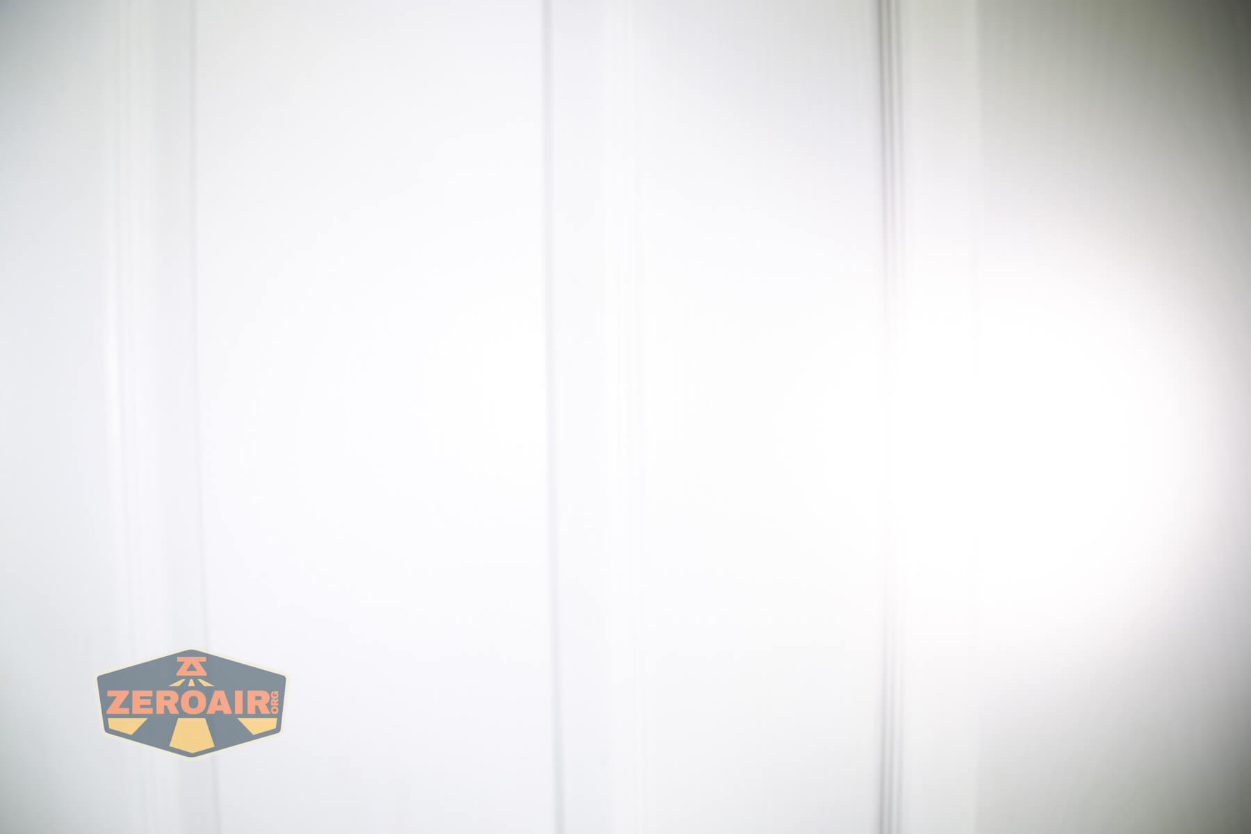 Olight Marauder Mini 2 Compact powerful flashlight beamshots on door compared to nichia 219b