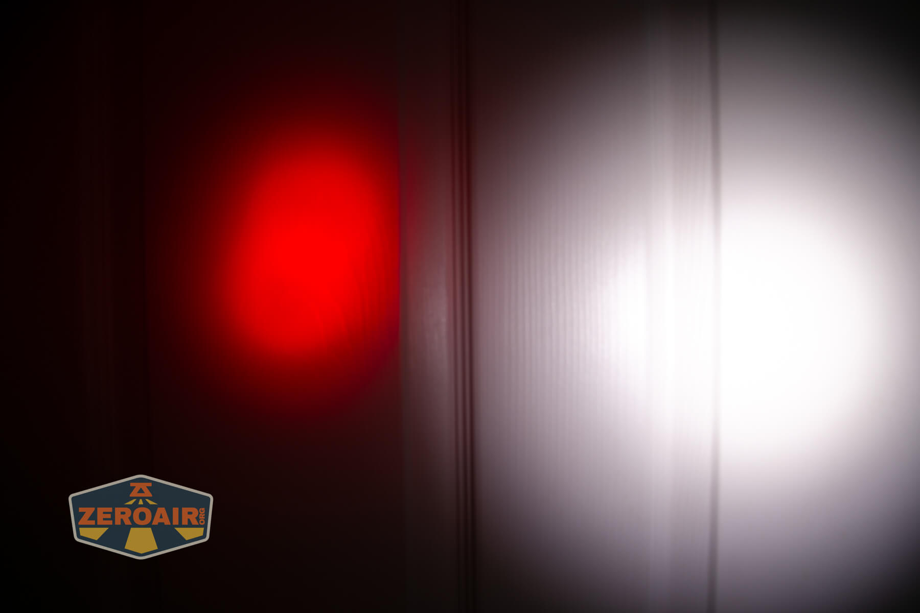 Olight Marauder Mini 2 Compact powerful flashlight beamshots on door compared to nichia 219b