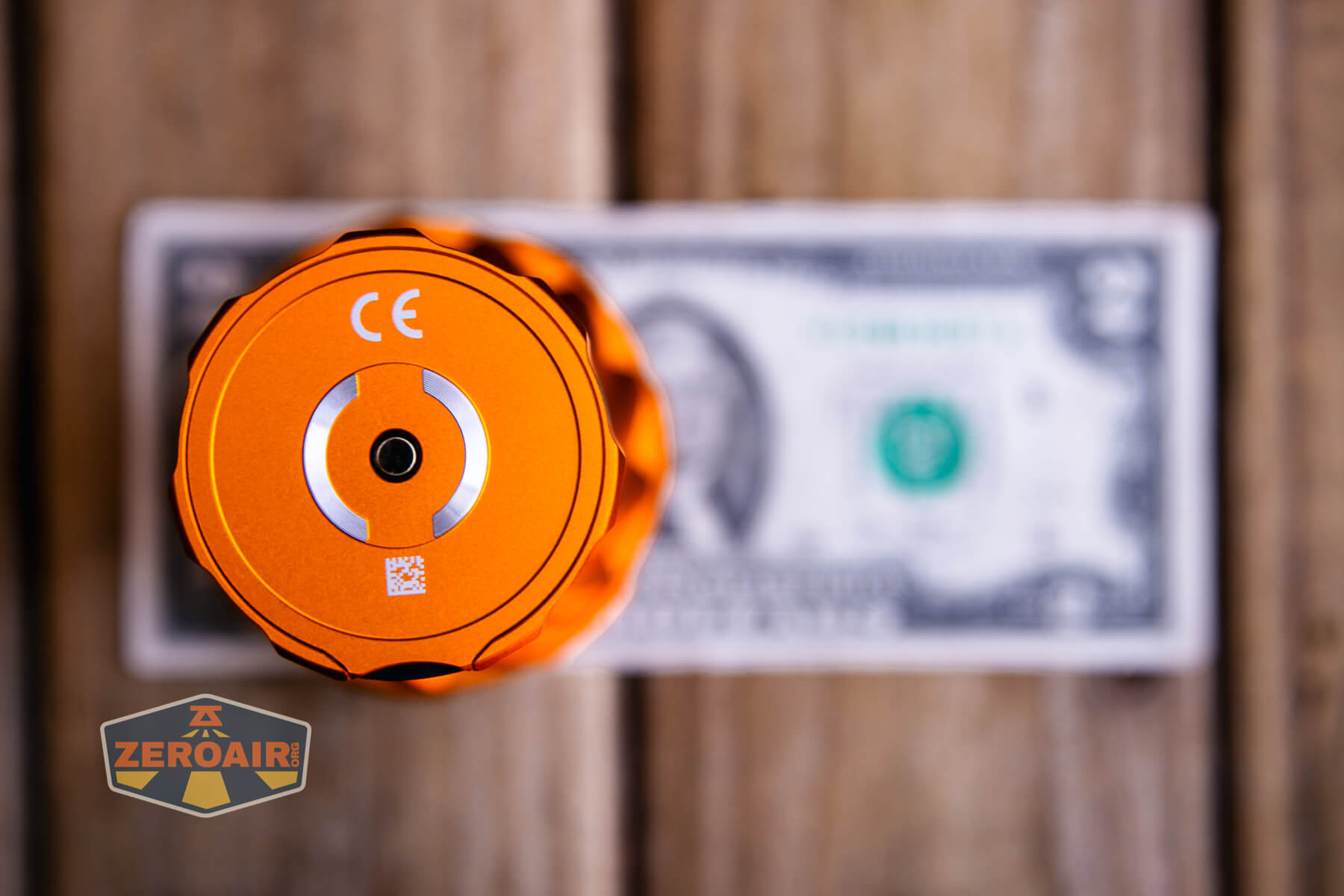 Olight Marauder Mini 2 Compact powerful flashlight on two dollar bill