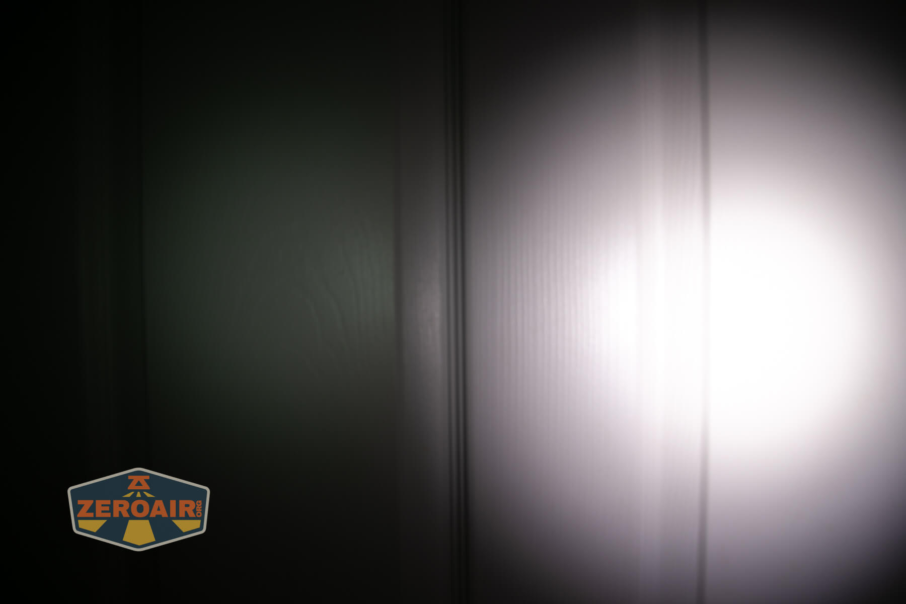 Olight Marauder Mini 2 Compact powerful flashlight beamshots on door compared to nichia 219b