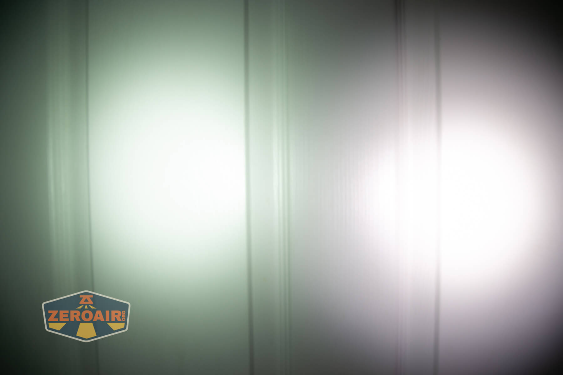 Olight Marauder Mini 2 Compact powerful flashlight beamshots on door compared to nichia 219b