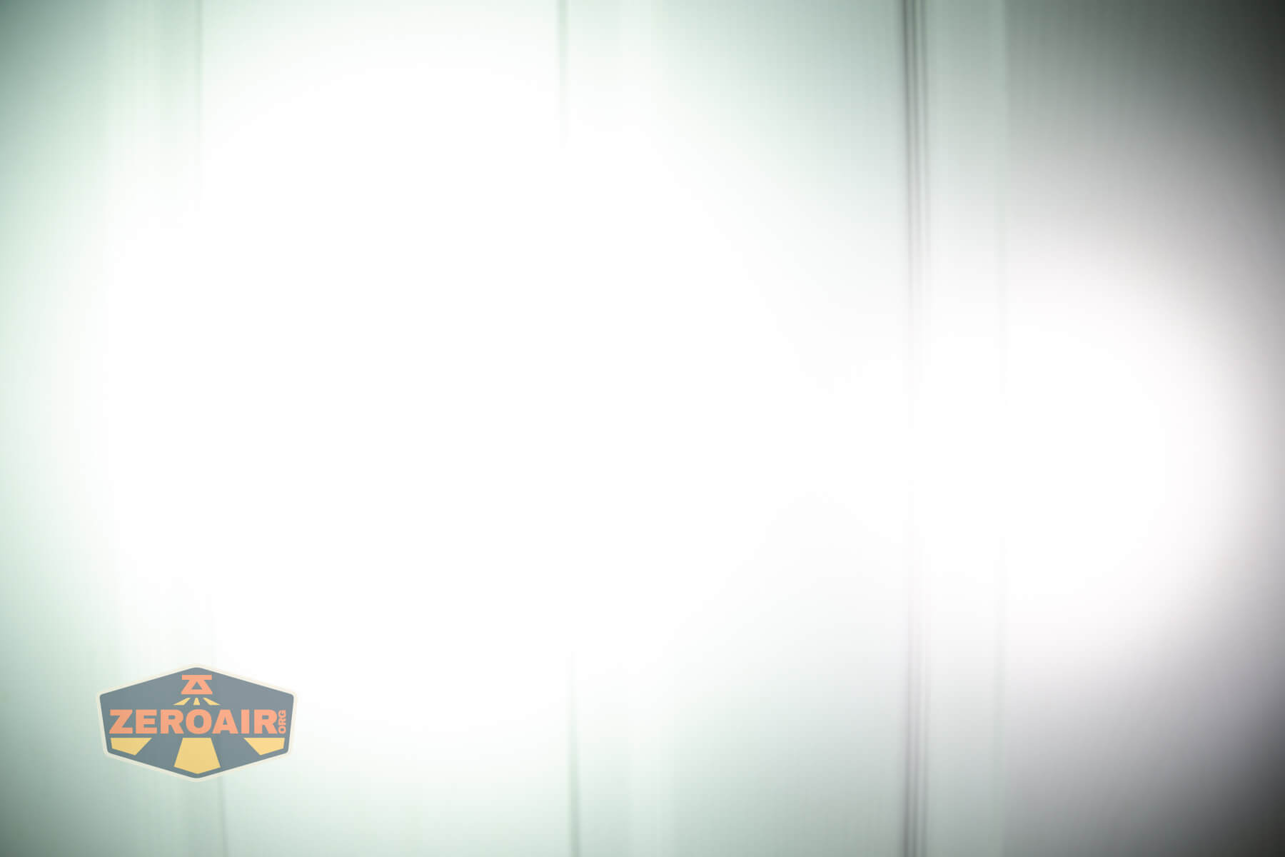 Olight Marauder Mini 2 Compact powerful flashlight beamshots on door compared to nichia 219b