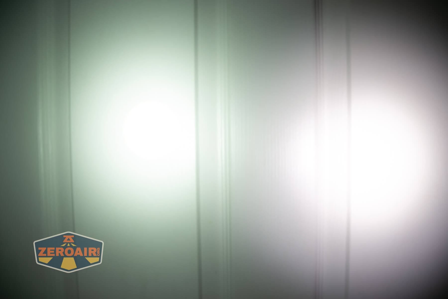 Olight Marauder Mini 2 Compact powerful flashlight beamshots on door compared to nichia 219b