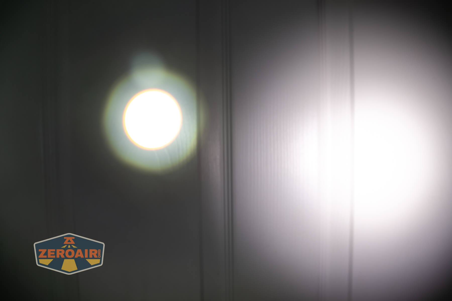 Olight Marauder Mini 2 Compact powerful flashlight beamshots on door compared to nichia 219b