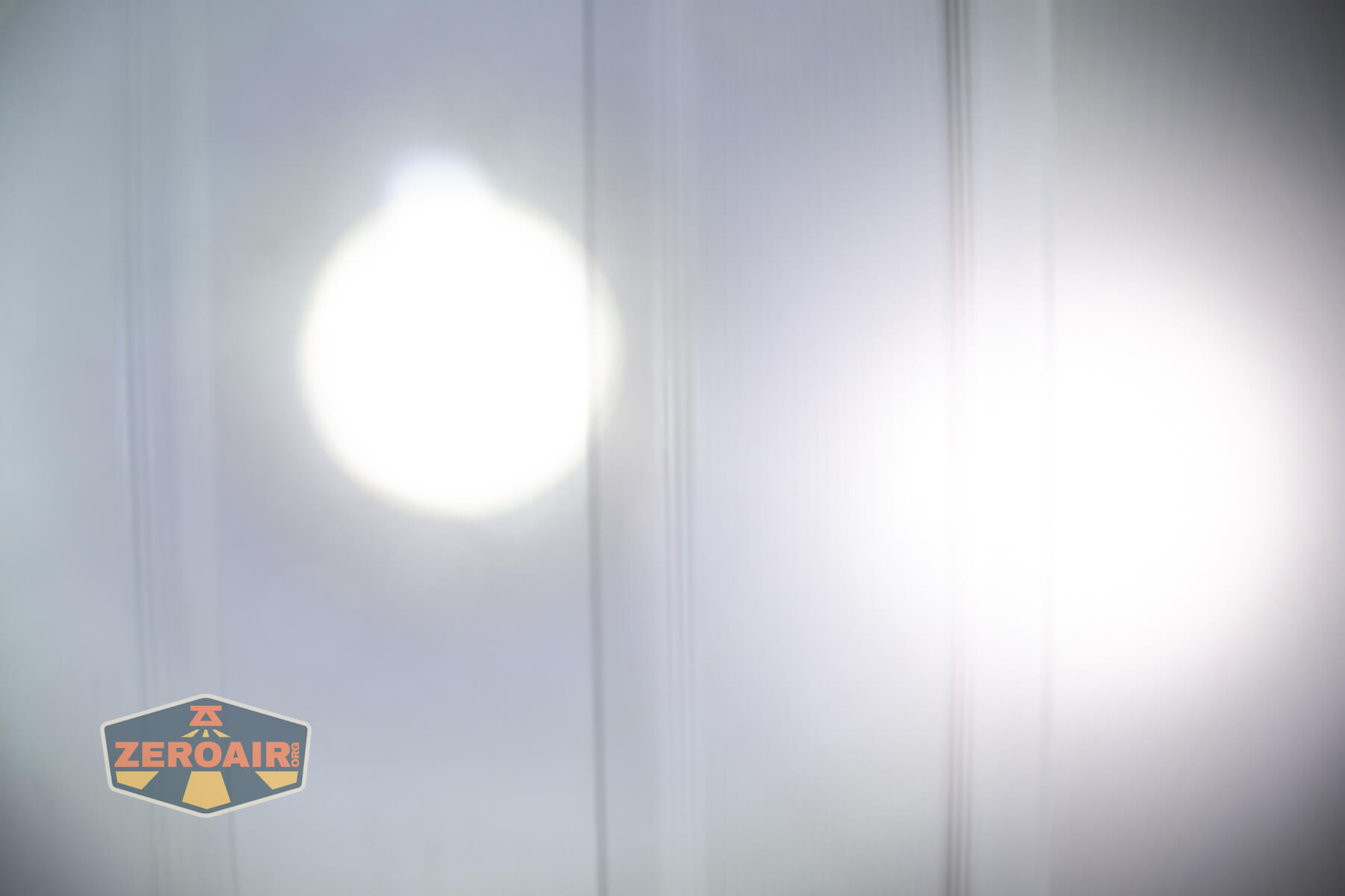 Olight Marauder Mini 2 Compact powerful flashlight beamshots on door compared to nichia 219b