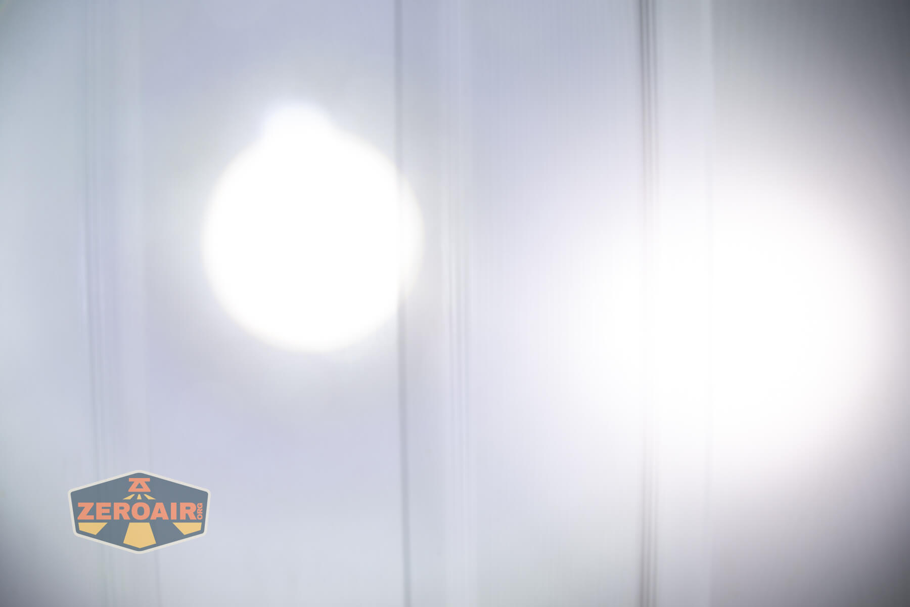 Olight Marauder Mini 2 Compact powerful flashlight beamshots on door compared to nichia 219b