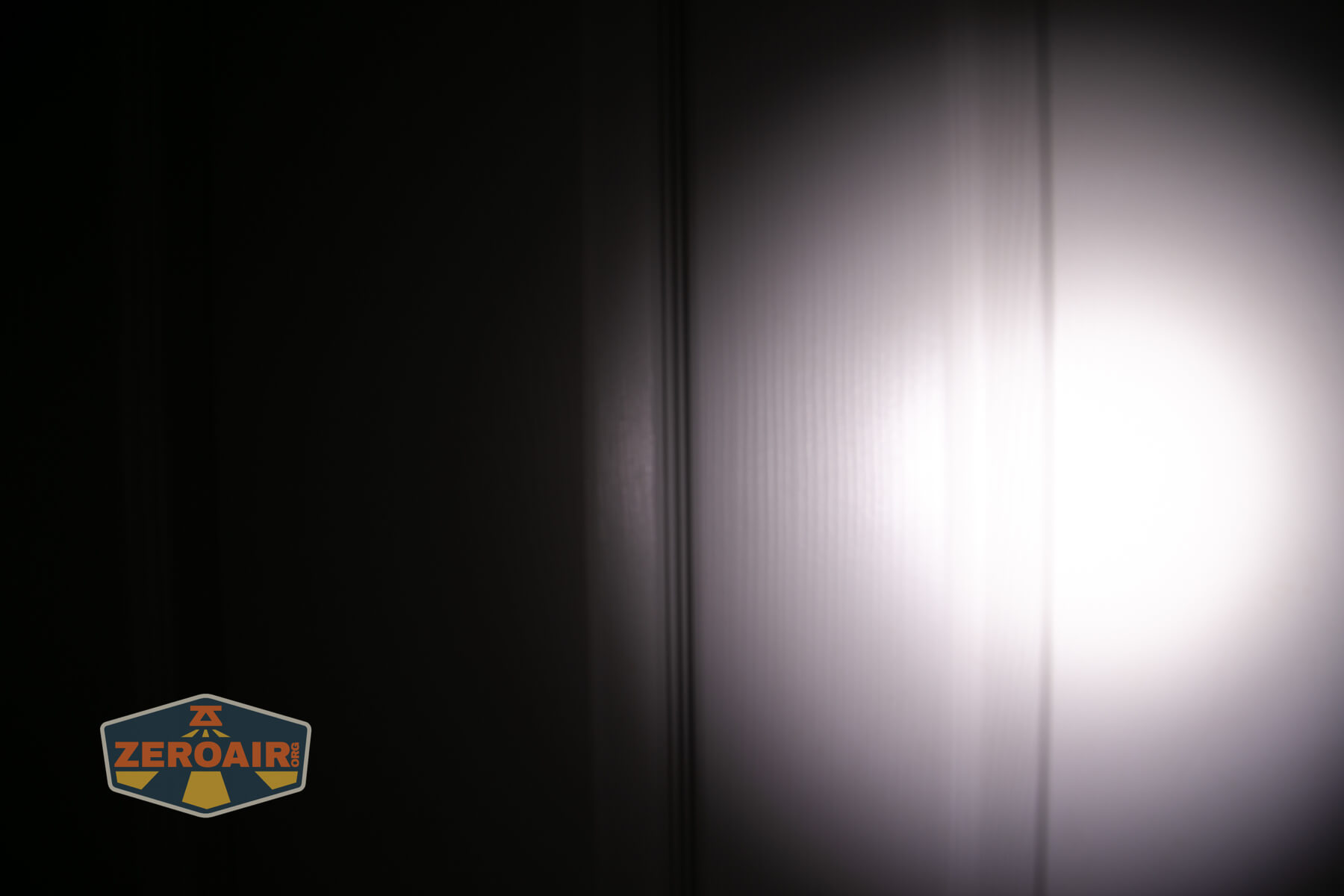 Olight Marauder Mini 2 Compact powerful flashlight beamshots on door compared to nichia 219b