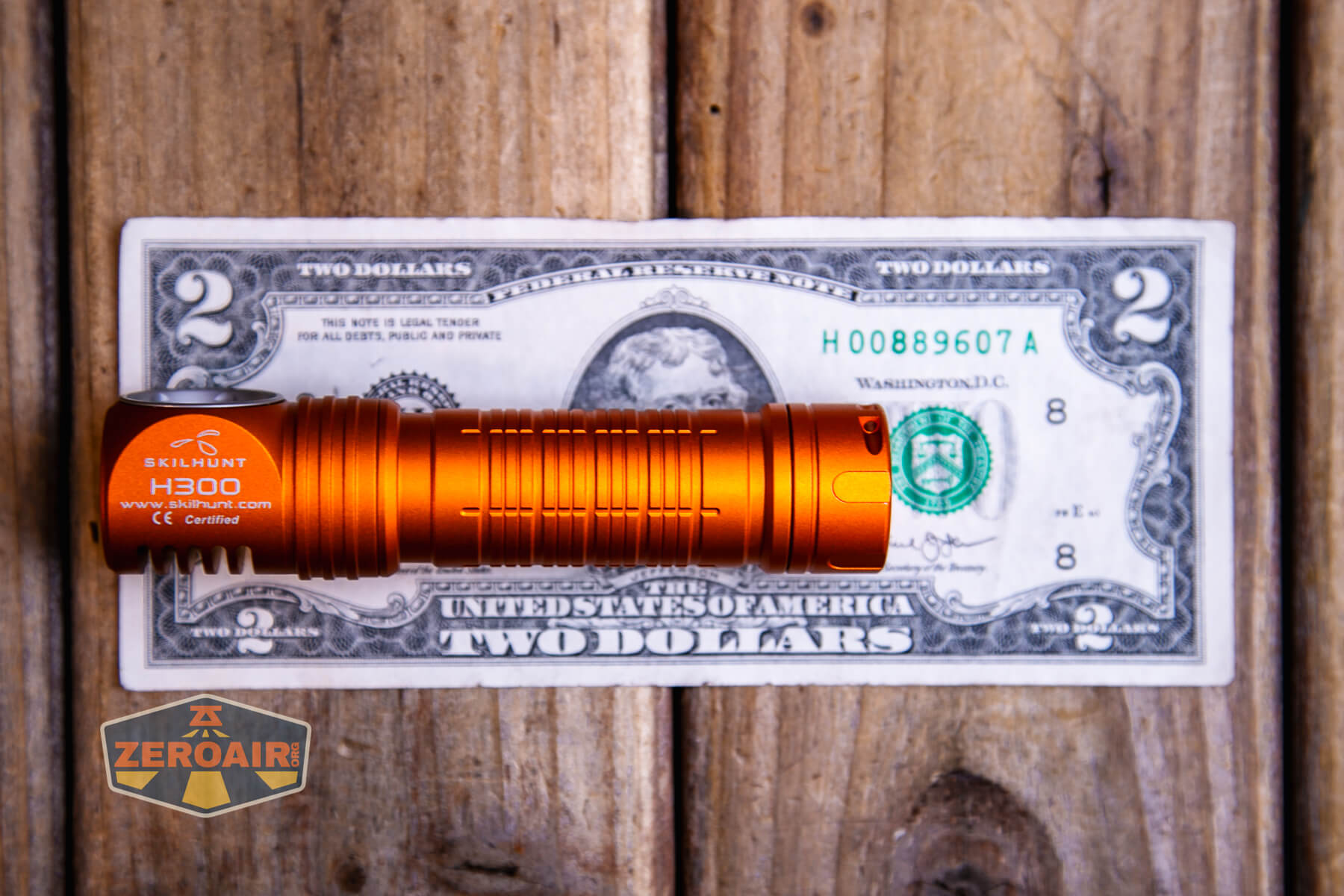 Skilhunt H300R v4 headlamp on two dollar bill
