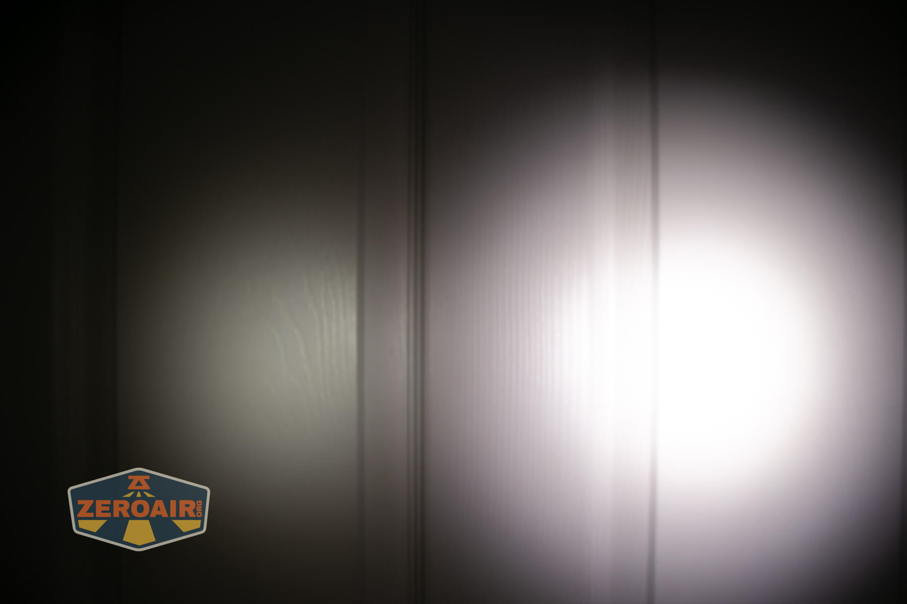 Skilhunt H300R v4 headlamp beamshots on door compared to nichia 219b