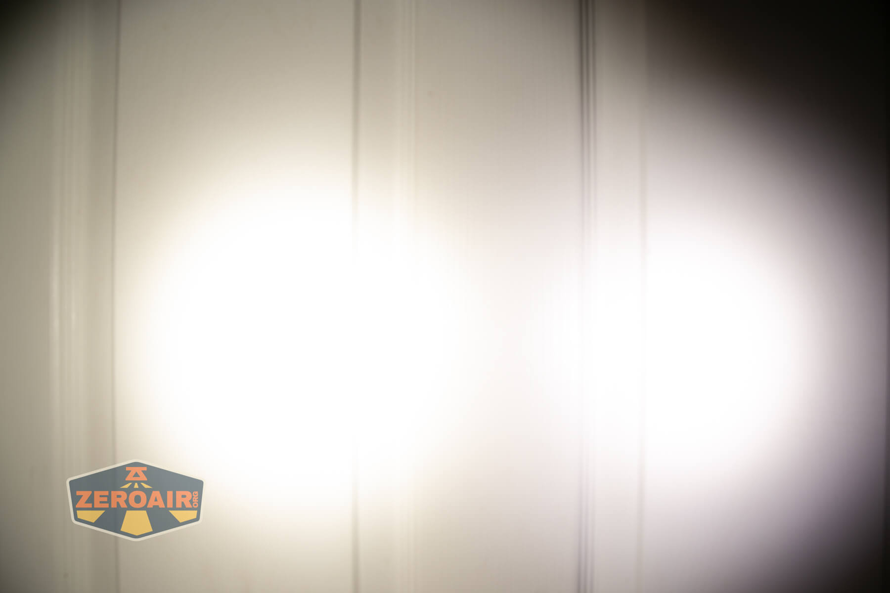 Skilhunt H300R v4 headlamp beamshots on door compared to nichia 219b