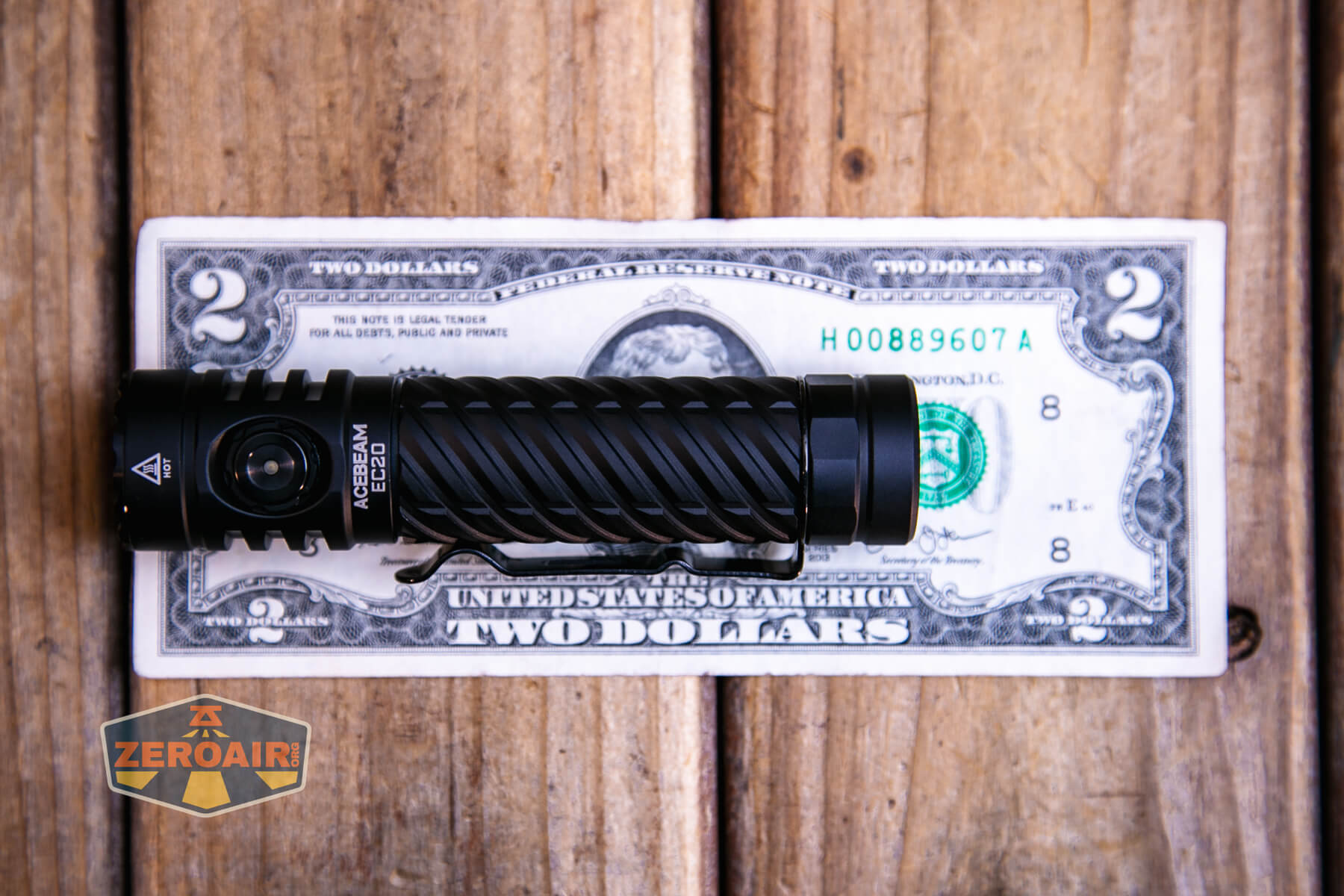 Acebeam EC20 multi-light source edc flashlight on a two dollar bill
