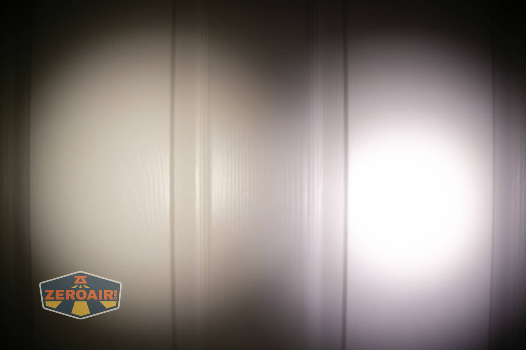 Acebeam EC20 multi-light source edc flashlight beamshots on door (at 1') compared to nichia 219b 4500K