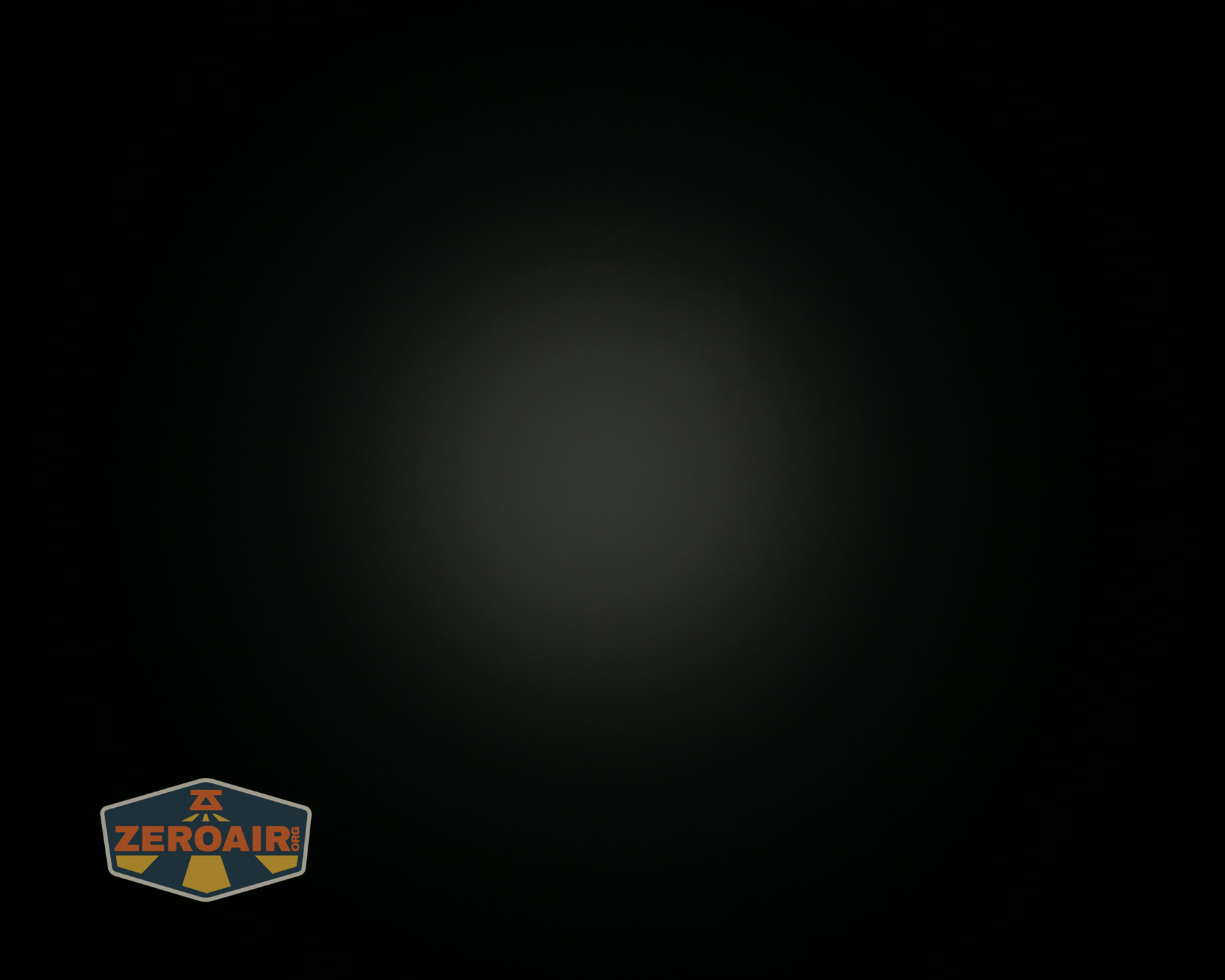 A faint circular light is visible in the center of a mostly black background. A shield-shaped logo with the word ZEROAIR appears in the lower left corner.
