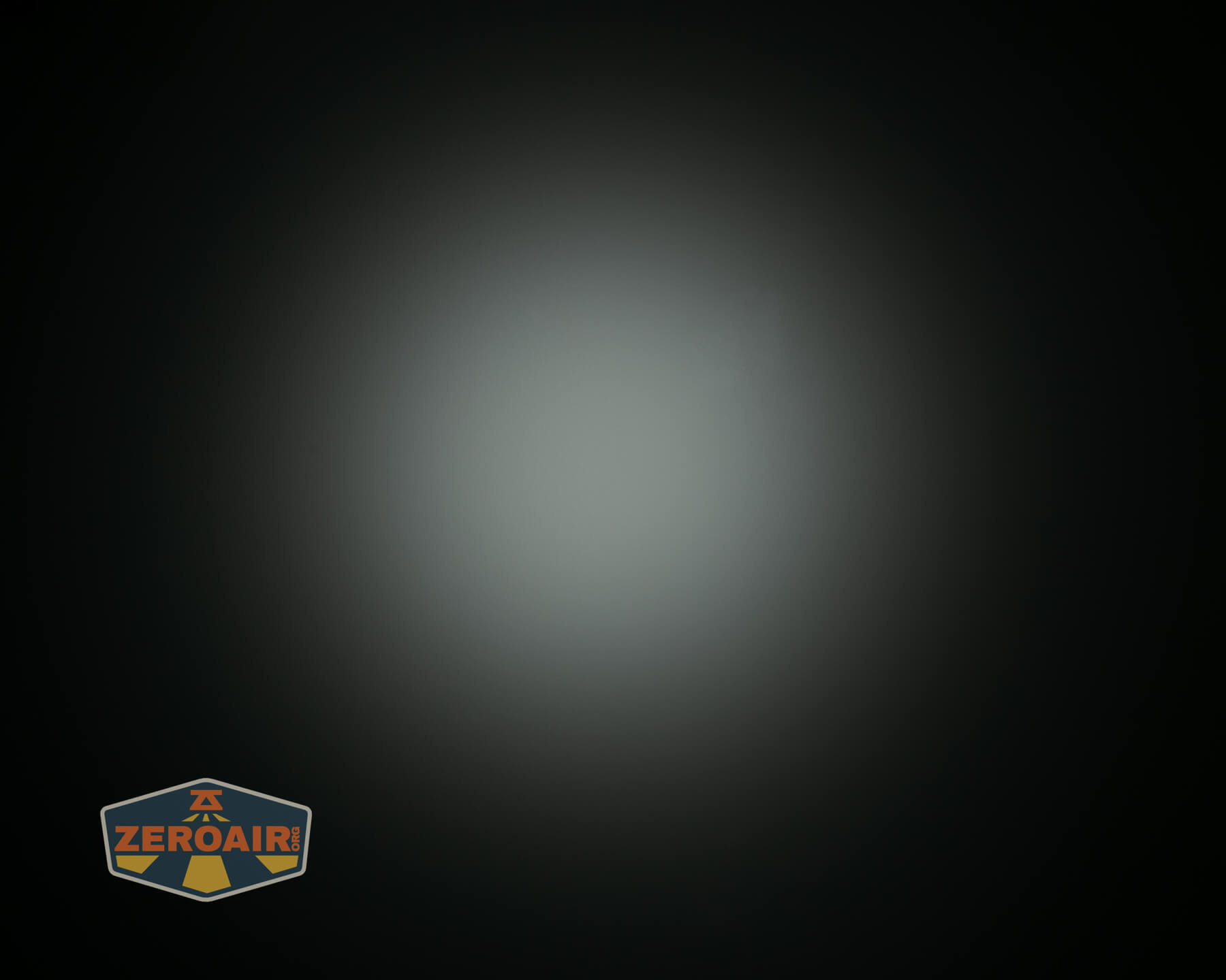 A circular white light beam with a soft gradient fades into black around the edges. The ZeroAir logo appears in the lower left corner.