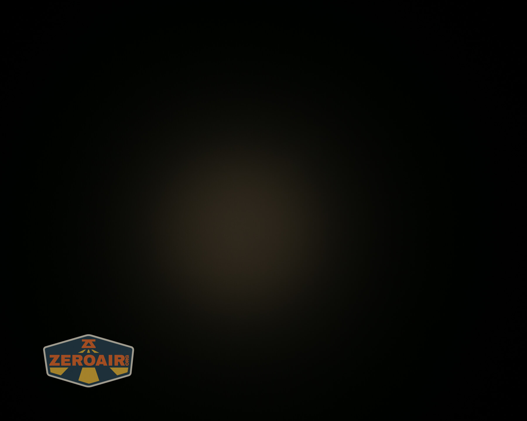 A dark image with a faint, dim circle of light in the center. The lower left corner features a ZeroAir logo in orange, gray, and blue.
