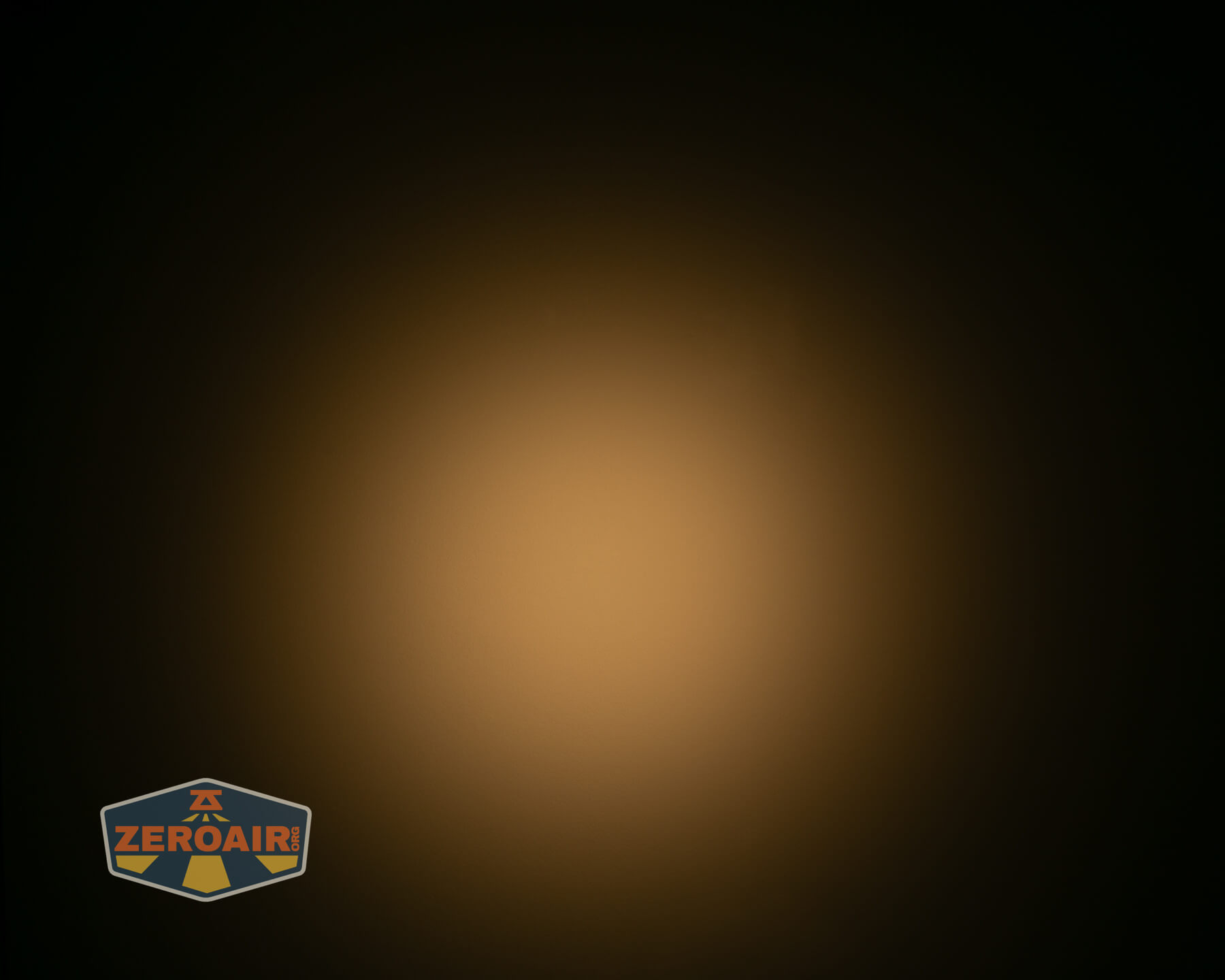 A circular yellowish light appears in the center of a dark background, creating a subtle gradient from light to dark. A ZeroAir logo is visible in the lower left corner.