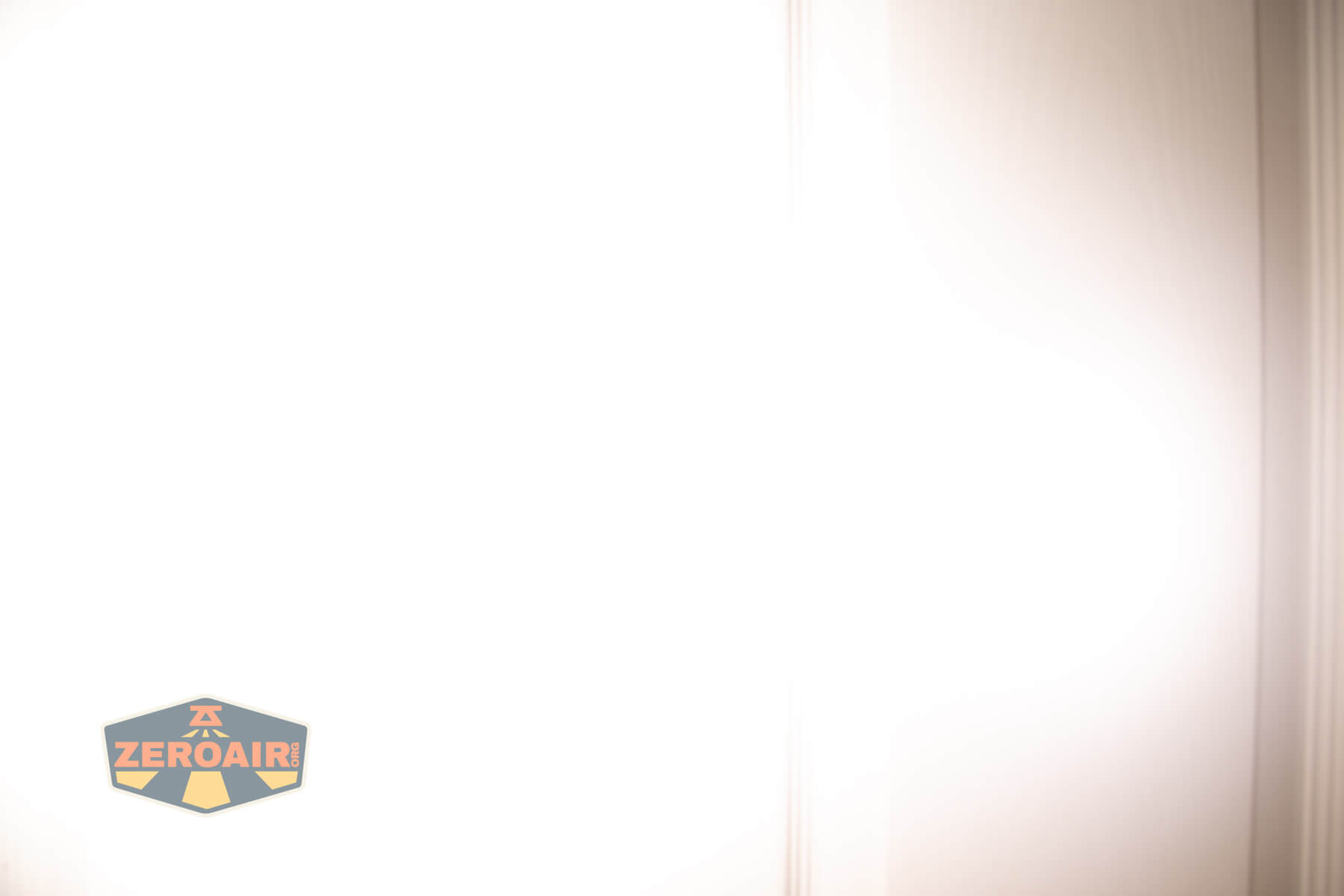 A bright white light fills most of the image, with some vertical shadows on the right. A small ZeroAir logo appears in the bottom left corner.