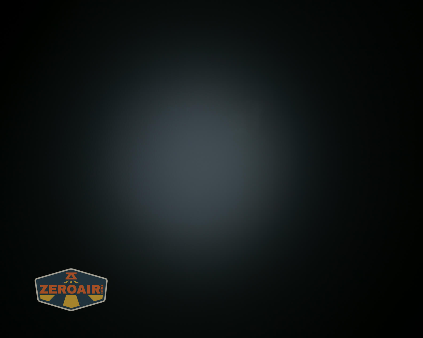 A dark photo showing a soft, circular beam of light in the center with a ZeroAir logo in the lower left corner. The background is mostly black with a fading gradient toward the middle.