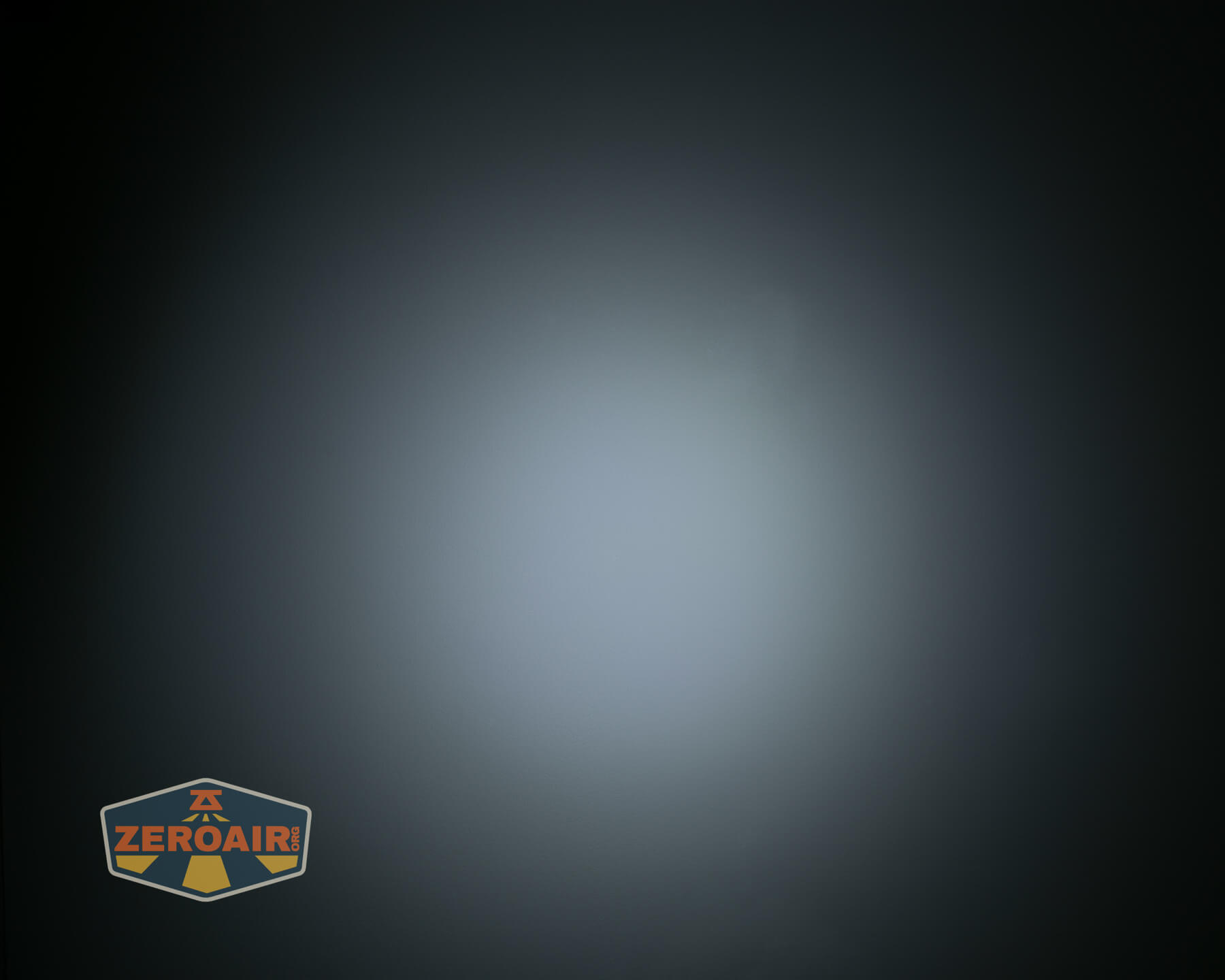 A circular white light is centered against a dark background, creating a fading halo effect. A logo with the text “ZEROAIR” appears in the bottom left corner.