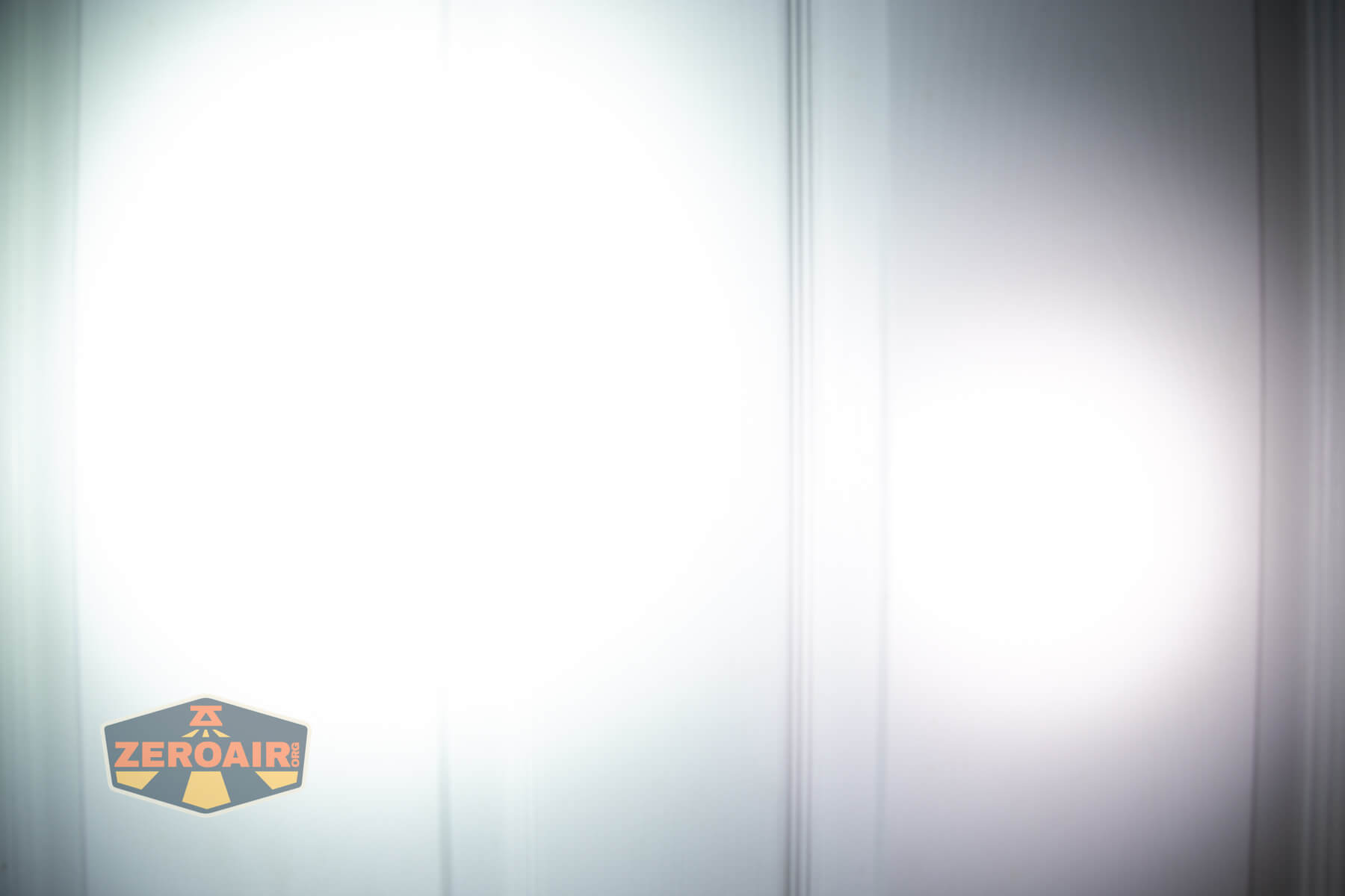 Sofirn HS43 headlamp beamshots on door (at 1') compared to nichia 219b 4500K