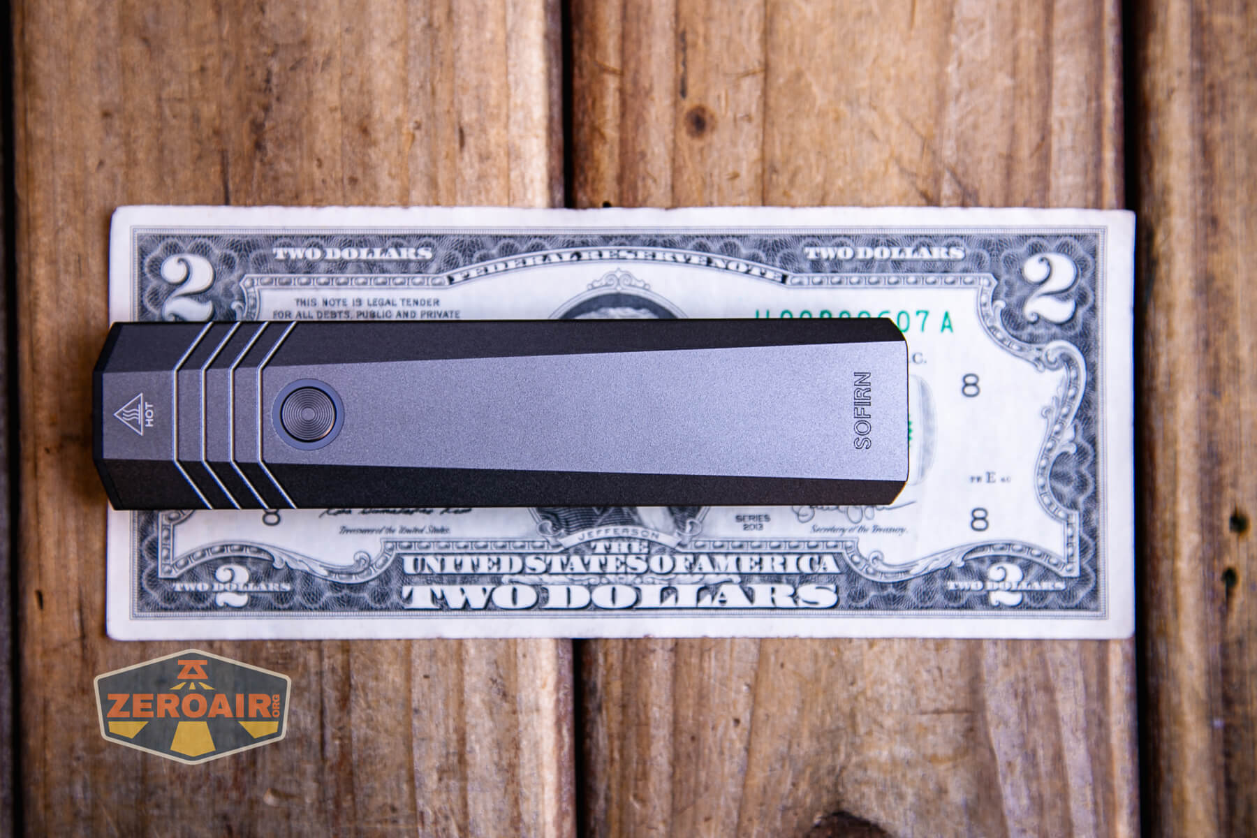 SOFIRN ST1 rechargeable flat EDC flashlight on a two dollar bill