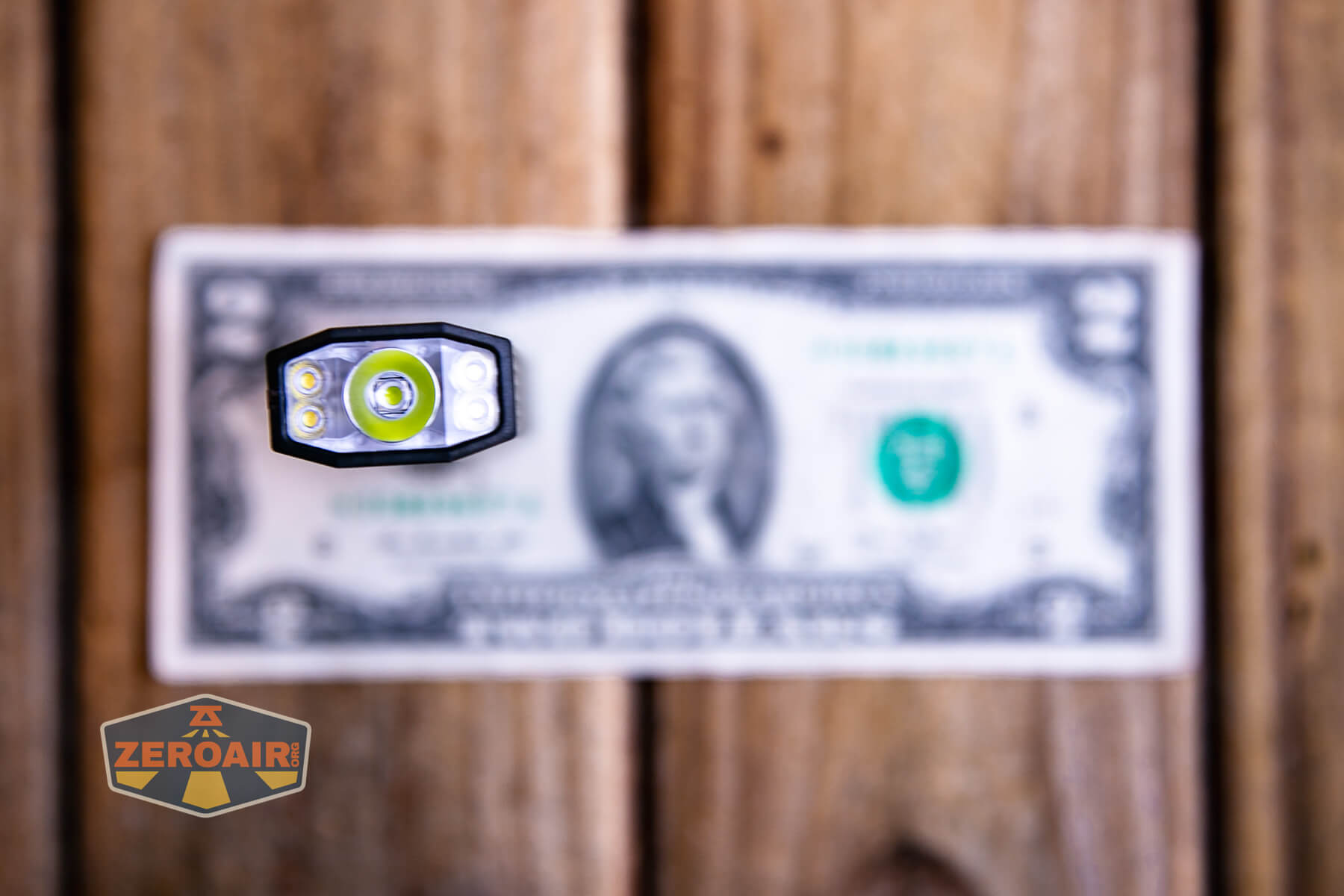 SOFIRN ST1 rechargeable flat EDC flashlight on a two dollar bill