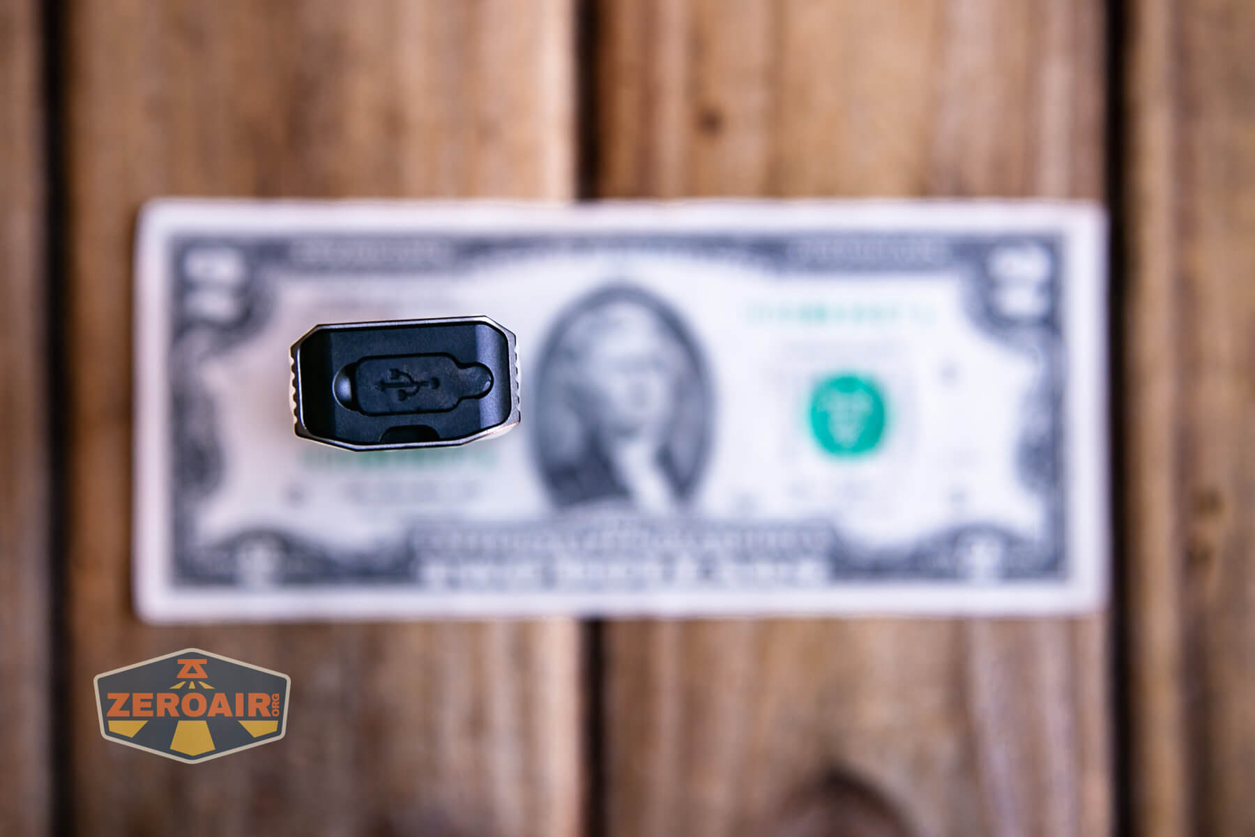 SOFIRN ST1 rechargeable flat EDC flashlight on a two dollar bill