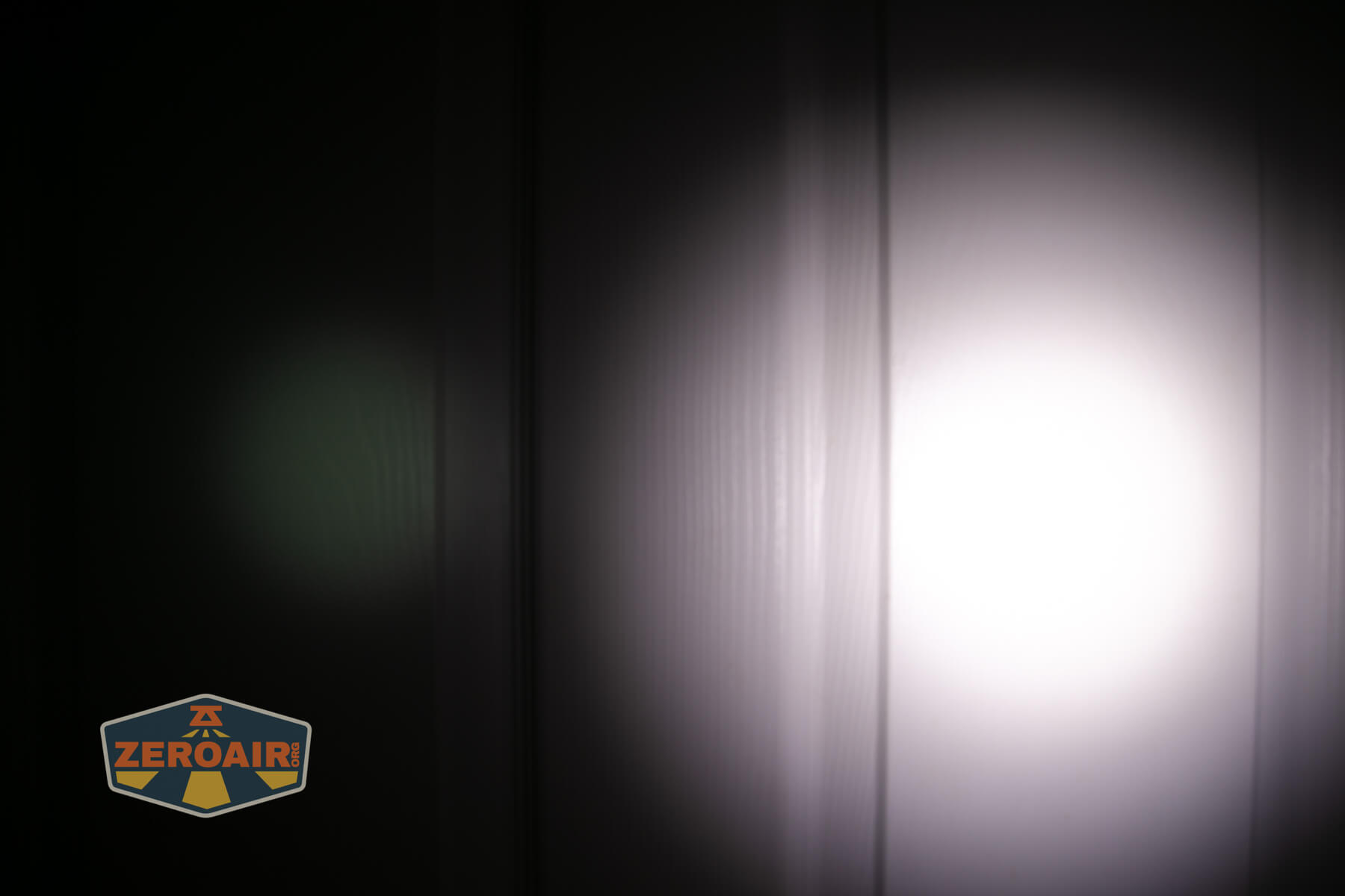 SOFIRN ST1 rechargeable flat EDC flashlight beamshots on door (at 1') compared to nichia 219b 4500K