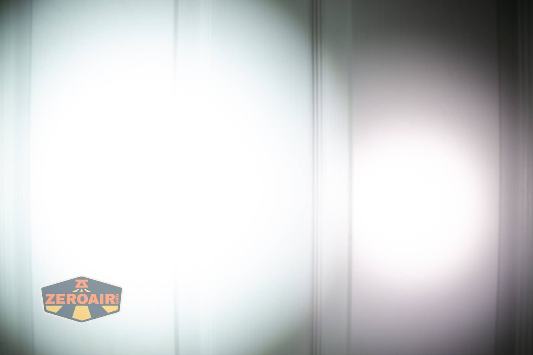 SOFIRN ST1 rechargeable flat EDC flashlight beamshots on door (at 1') compared to nichia 219b 4500K