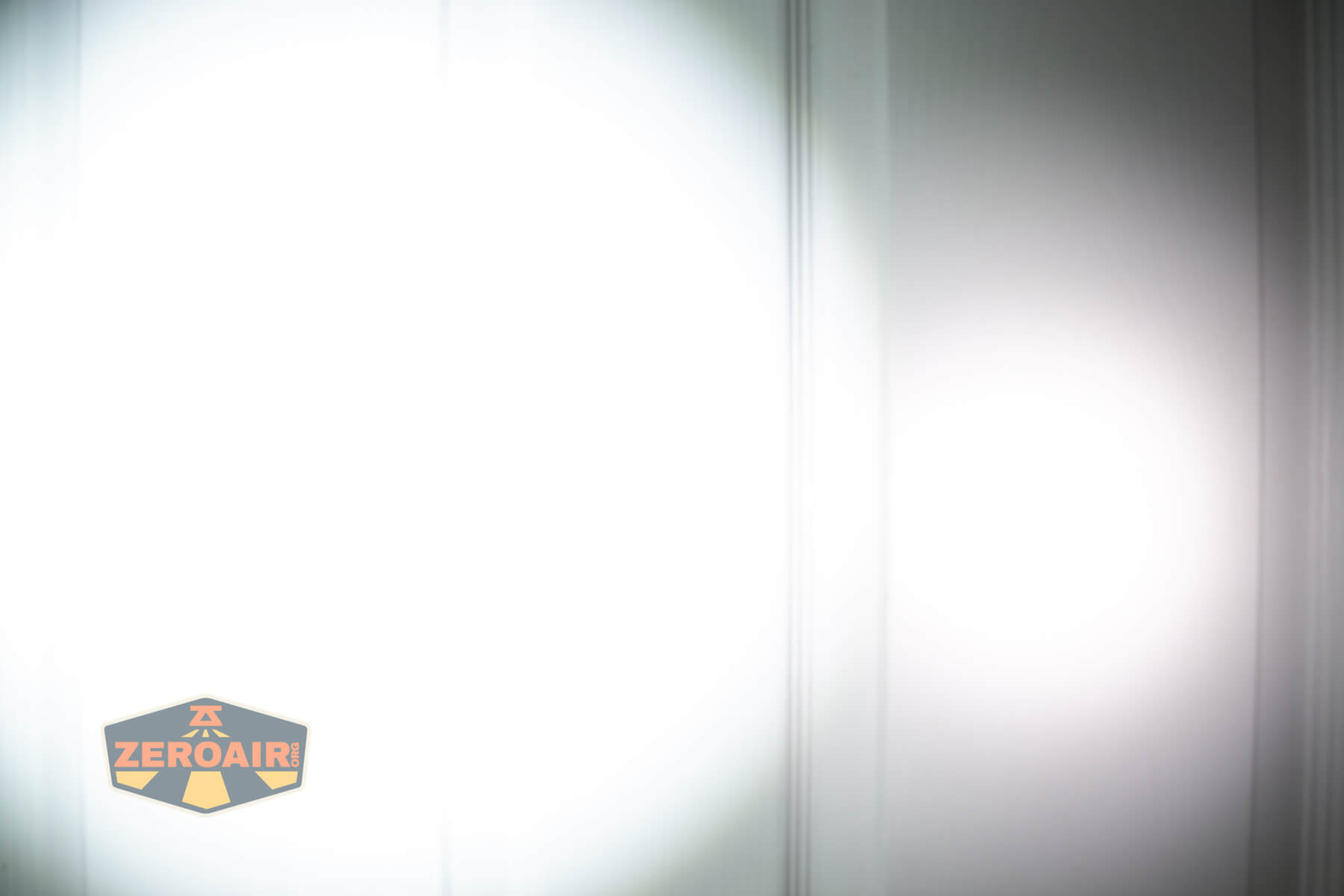 SOFIRN ST1 rechargeable flat EDC flashlight beamshots on door (at 1') compared to nichia 219b 4500K