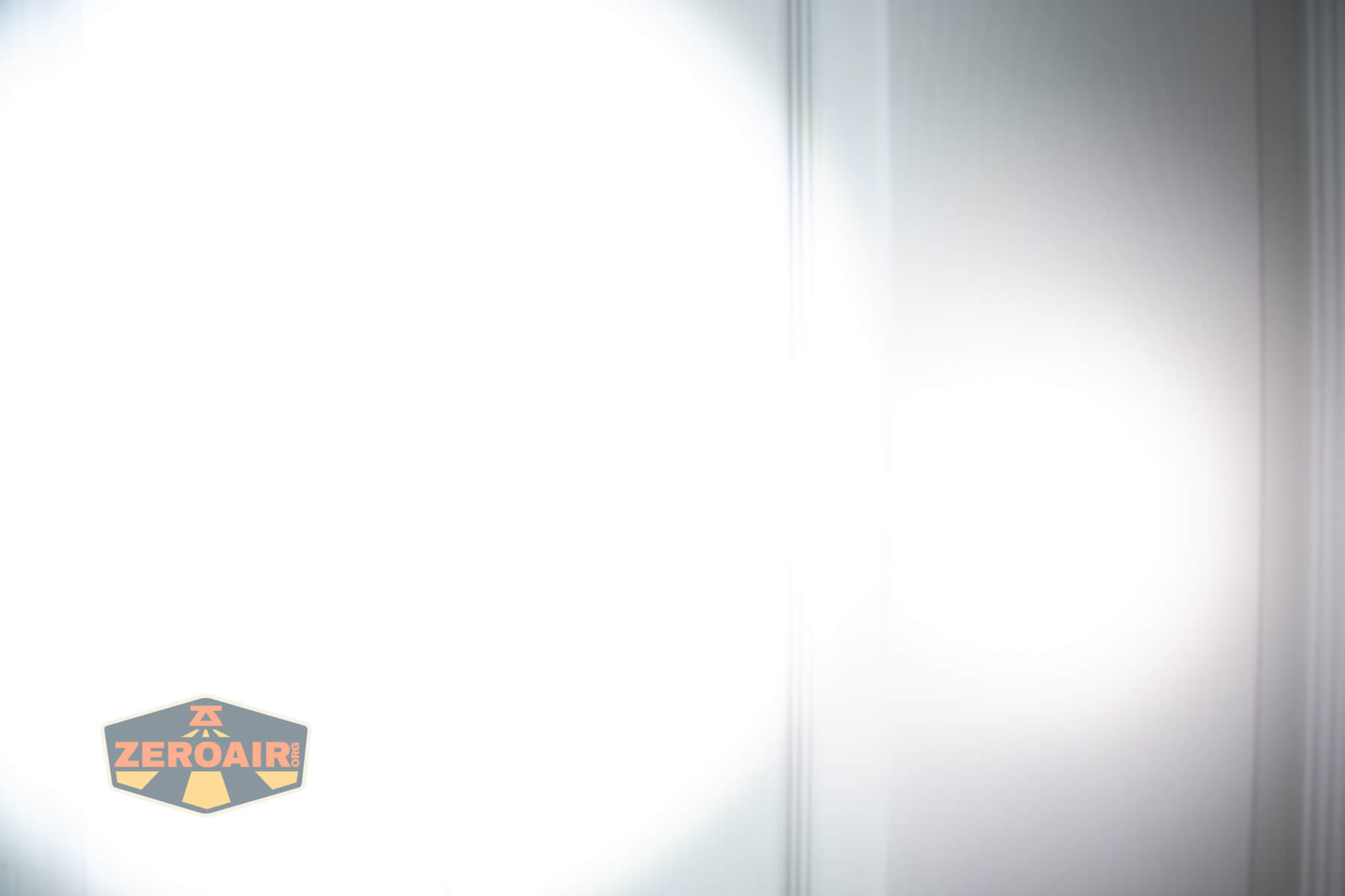 SOFIRN ST1 rechargeable flat EDC flashlight beamshots on door (at 1') compared to nichia 219b 4500K