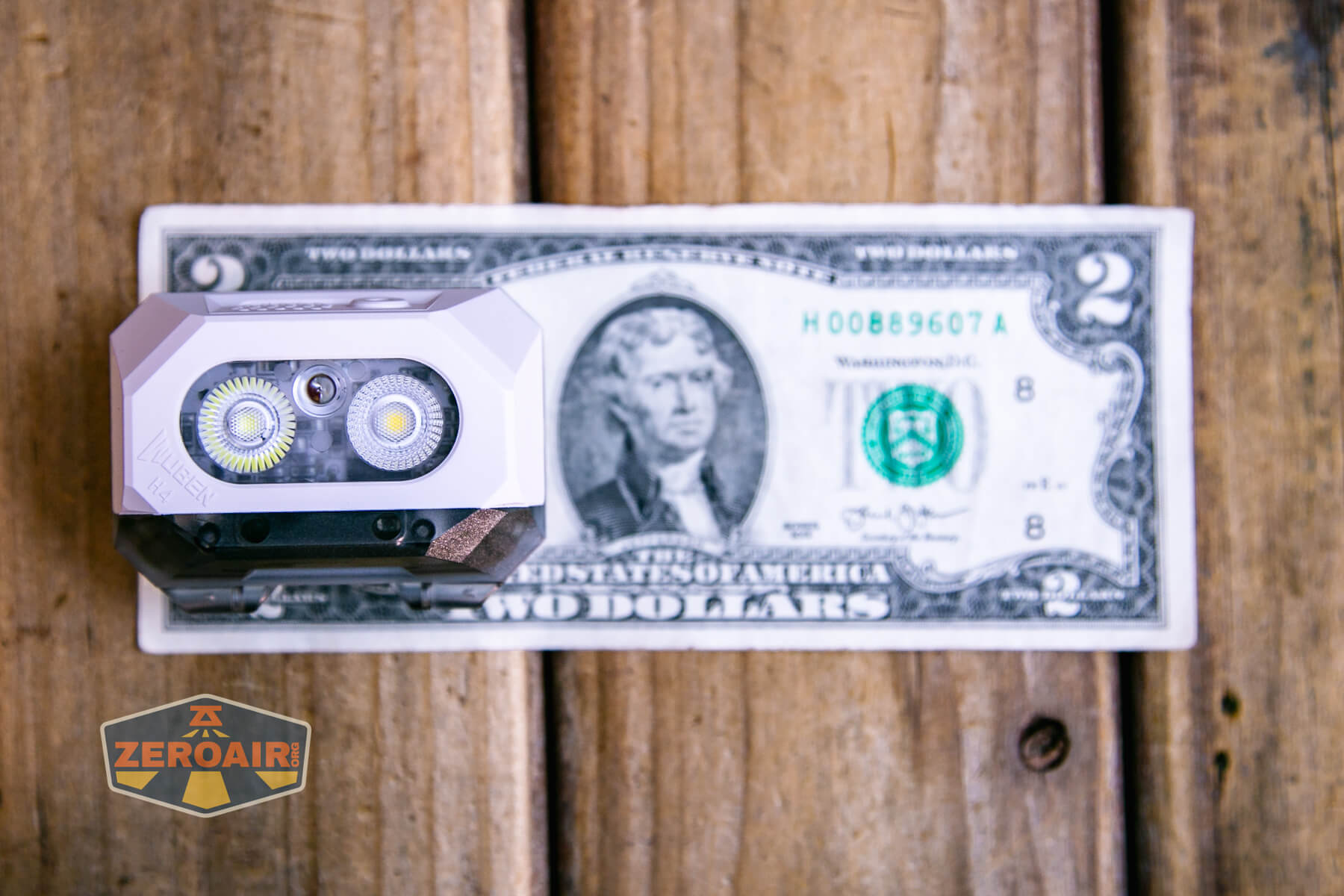 Wuben H4 Multi-function headlight on two dollar bill