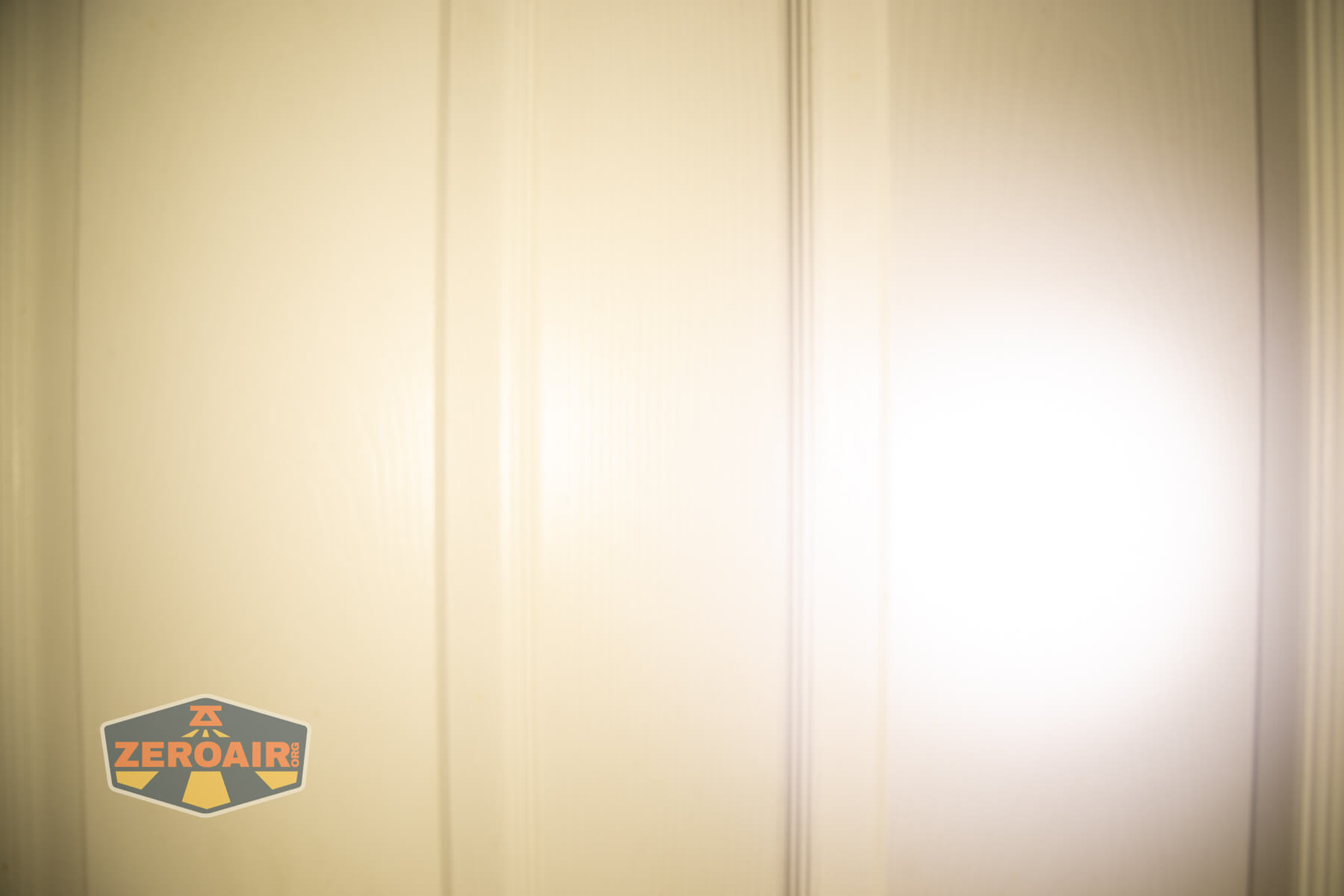 Wuben H4 Multi-function headlight beamshots on door compared to nichia 219b