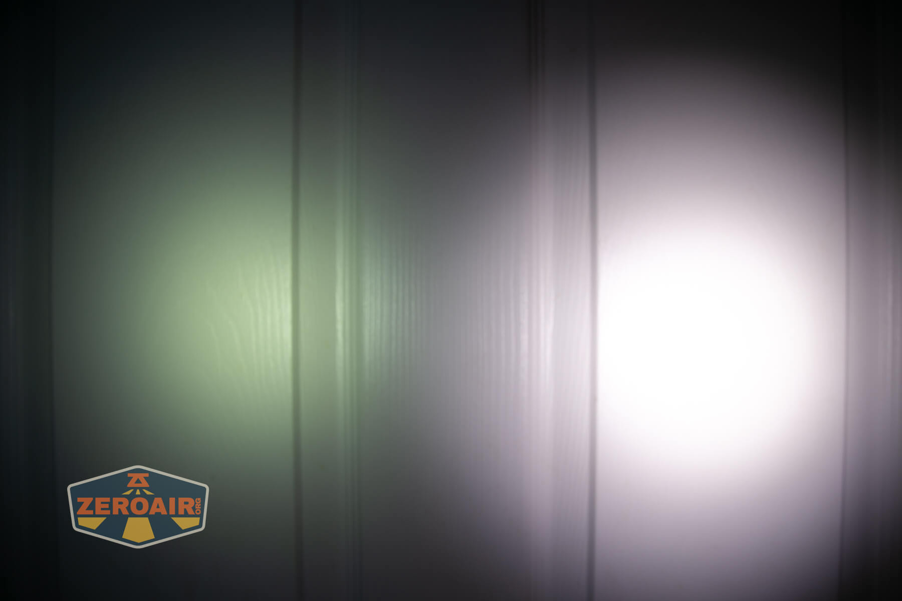 Wuben H4 Multi-function headlight beamshots on door compared to nichia 219b