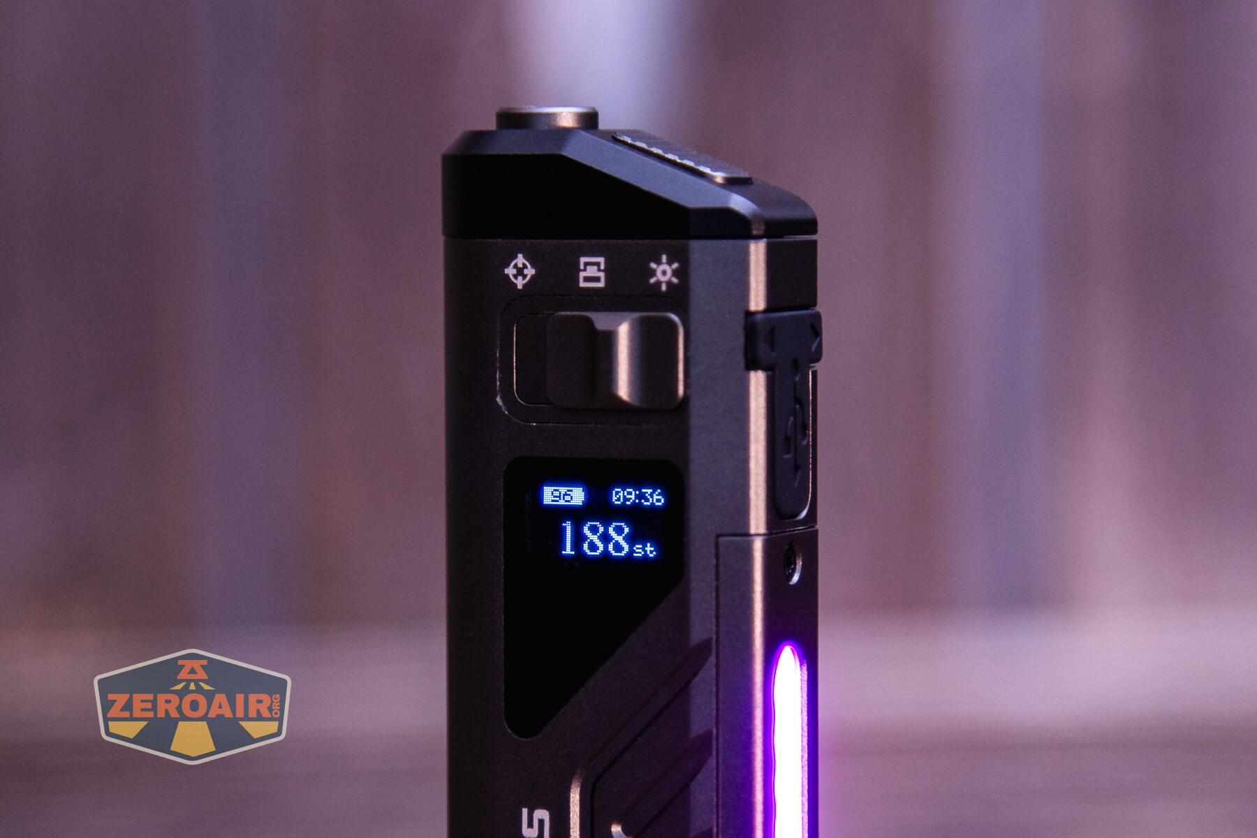 A close-up of a black electronic device with a digital display showing 188 St and battery indicators, illuminated by a side light strip. The background is blurred. A “ZeroAir” watermark is in the lower left corner.