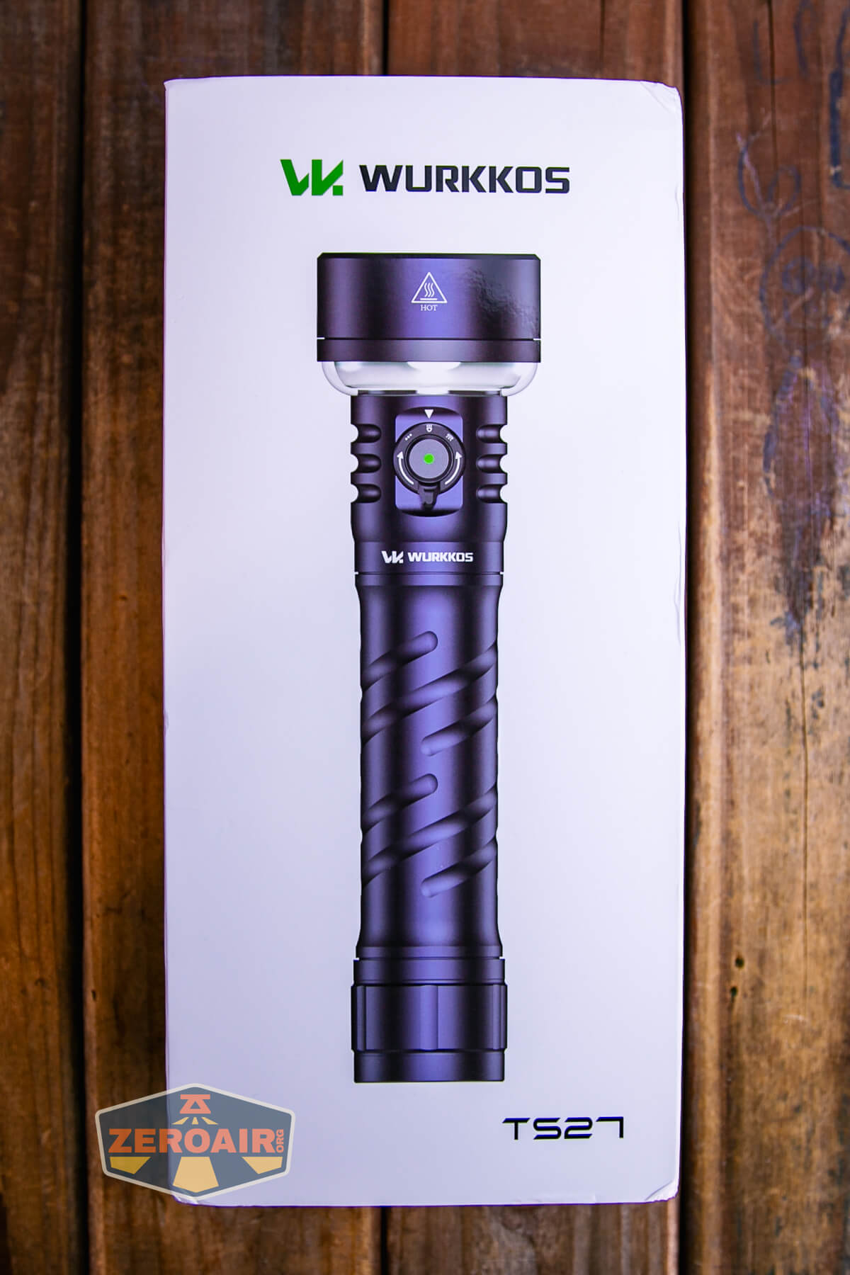 A Wurkkos TS27 flashlight is displayed on its white packaging box, with the flashlight image centered and brand logo and name at the top. The ZeroAir logo is in the lower left corner of the box.